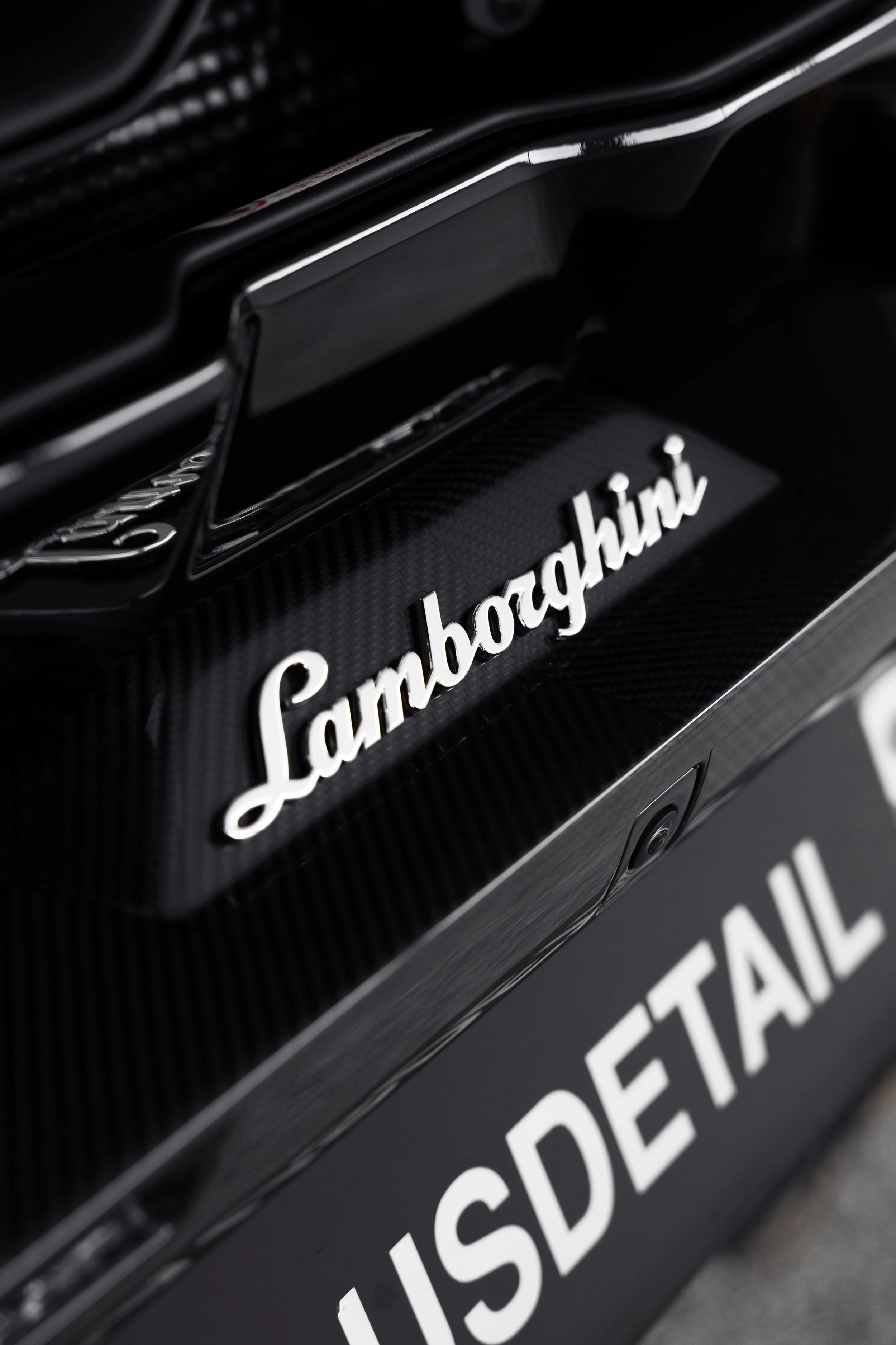 Lamborghini Revuelto rear badge detail with carbon fibre finish protected by PPF and detailing by ADS in Sydney