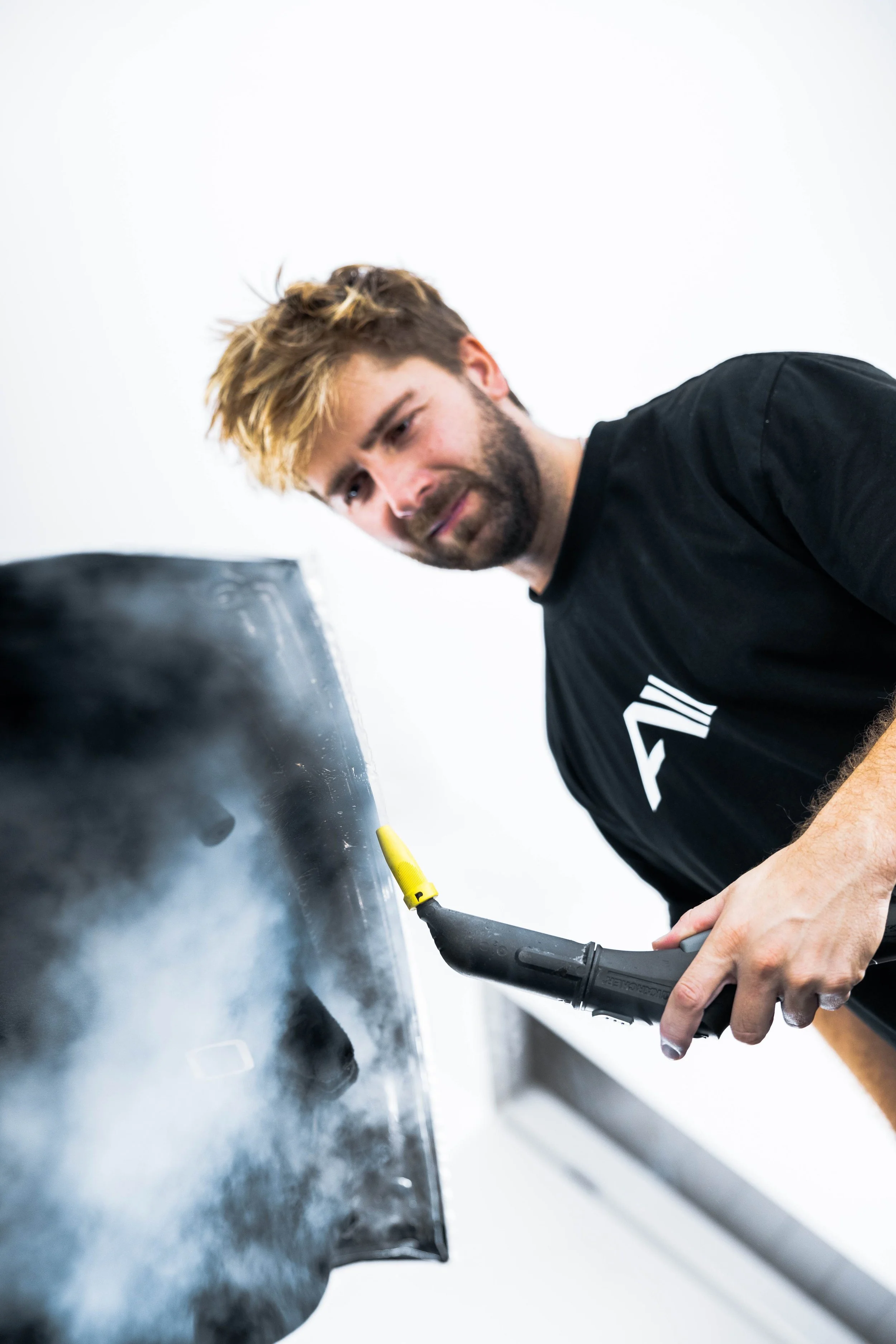 ADS technician heat forming XPEL Stealth Paint Protection Film on Tesla Model Y panel in Sydney