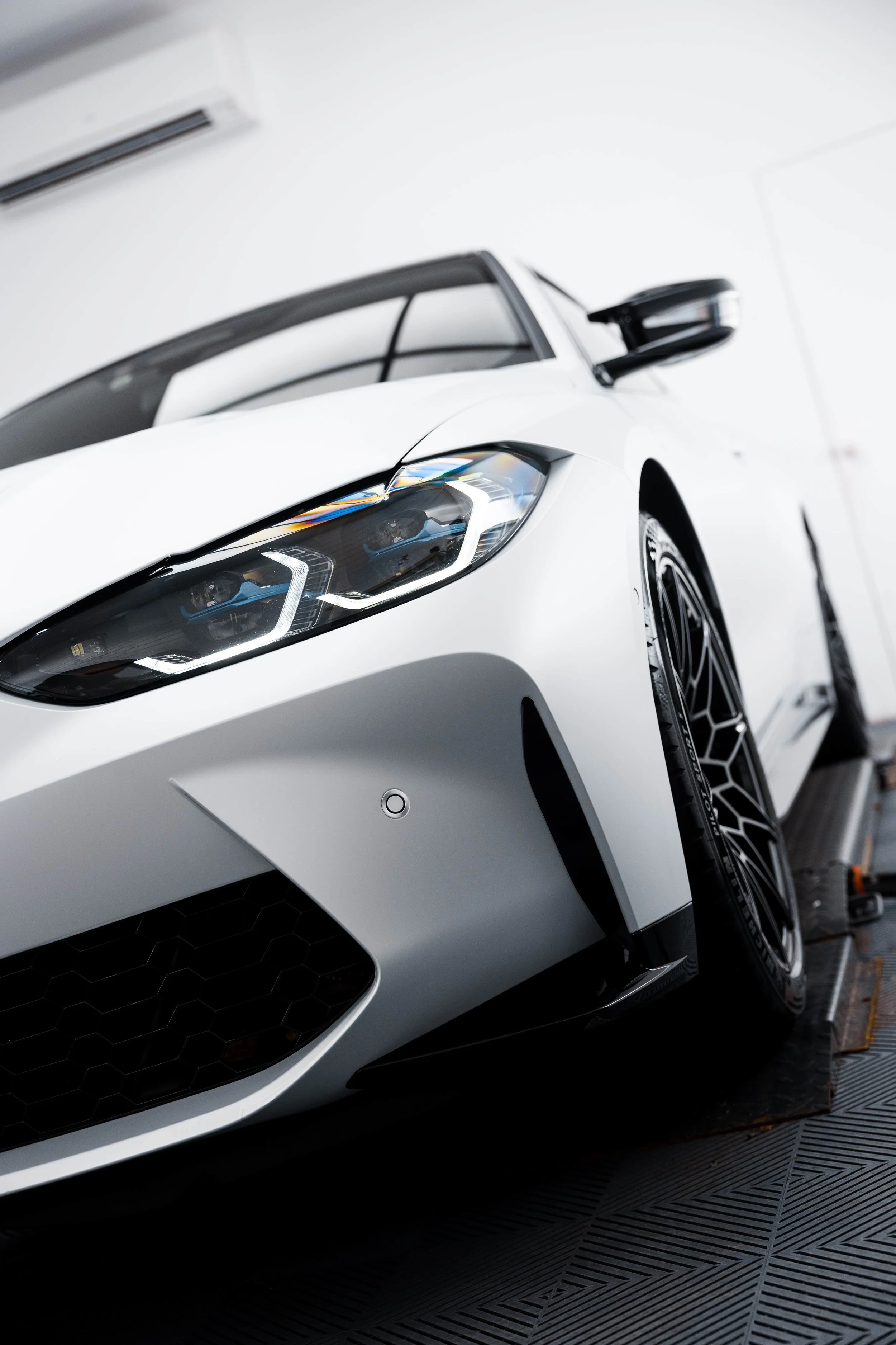 White BMW M4 Competition front bumper with XPEL Paint Protection Film in Mona Vale