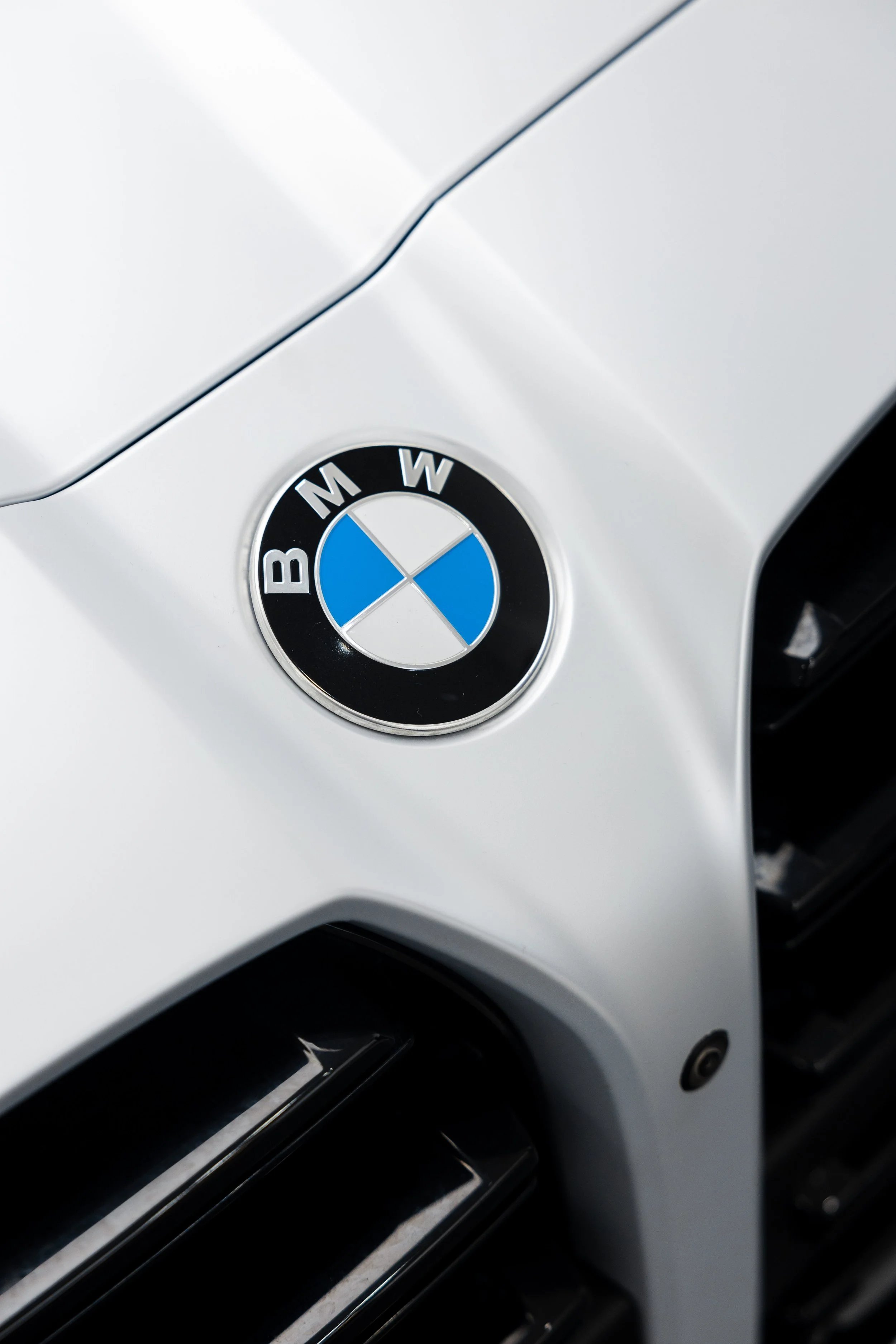 BMW badge on white BMW M4 Competition with XPEL Paint Protection Film in Mona Vale