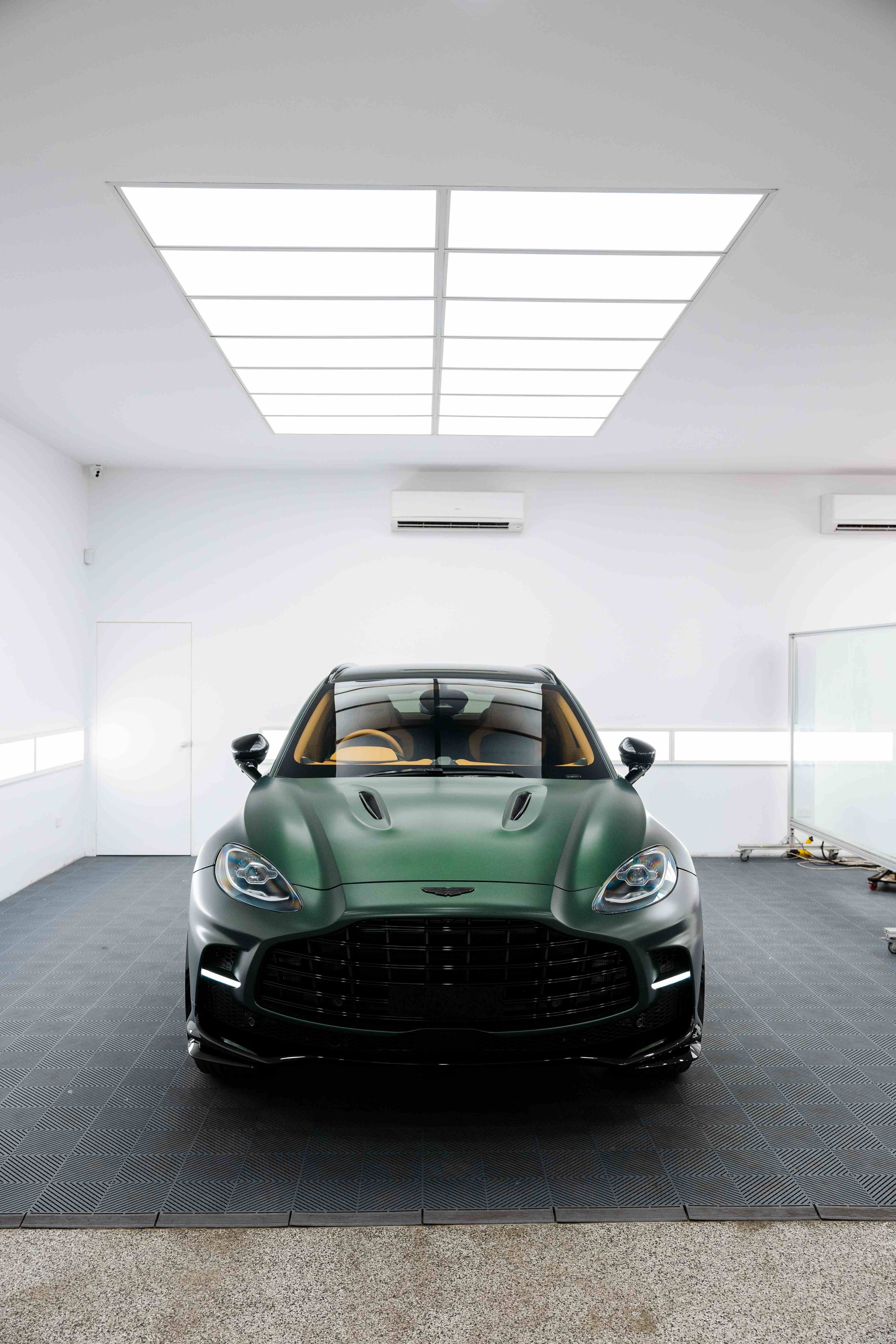Matte green Aston Martin DBX front view in studio with XPEL Stealth Paint Protection Film in Mona Vale