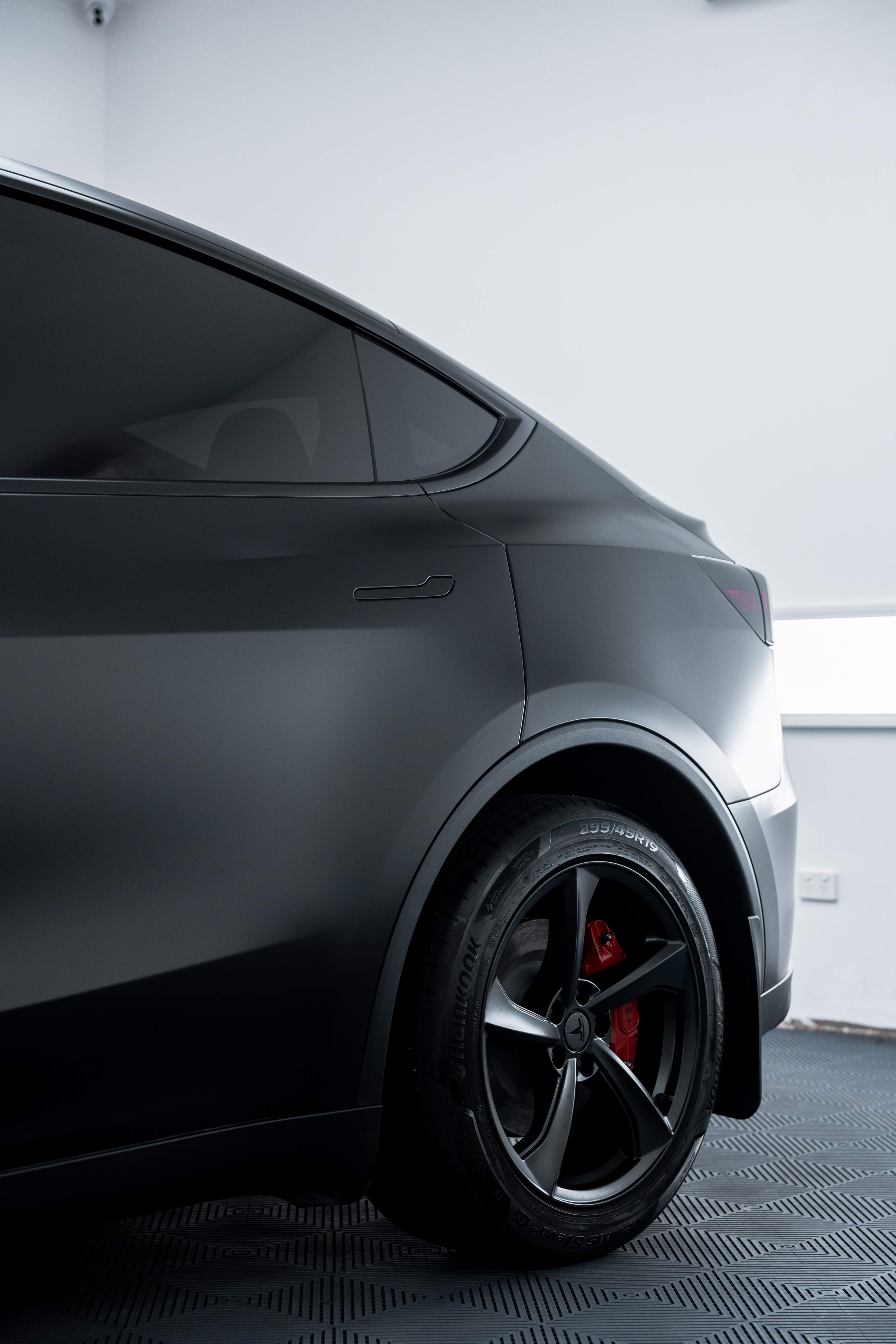 Matte black Tesla Model Y rear quarter and wheel with XPEL Stealth Paint Protection Film in Mona Vale
