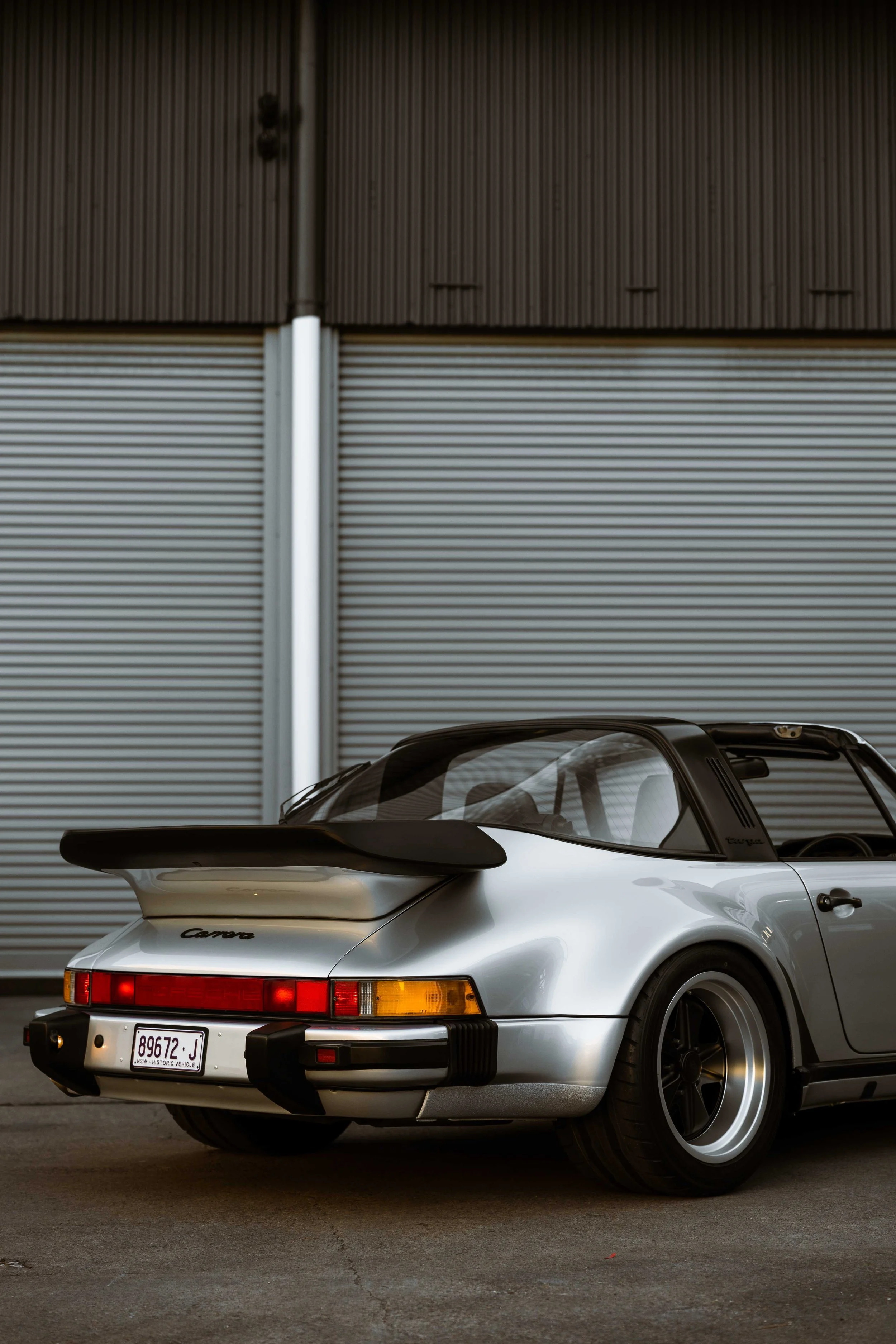 Silver 1989 Porsche 911 Carrera Targa rear whale tail and taillights in Mona Vale