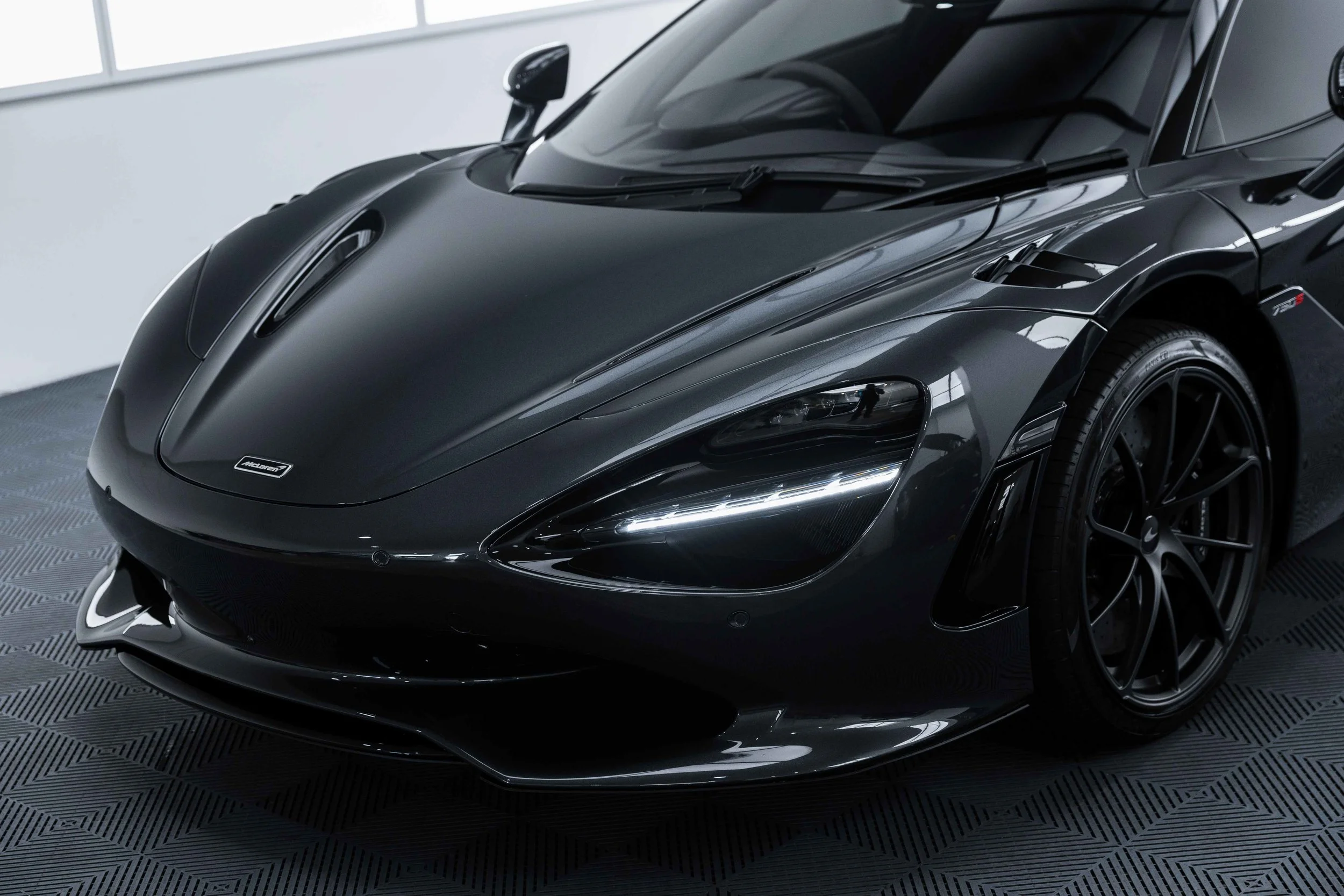 Black McLaren 750S front bumper and headlight with XPEL Paint Protection Film in Sydney