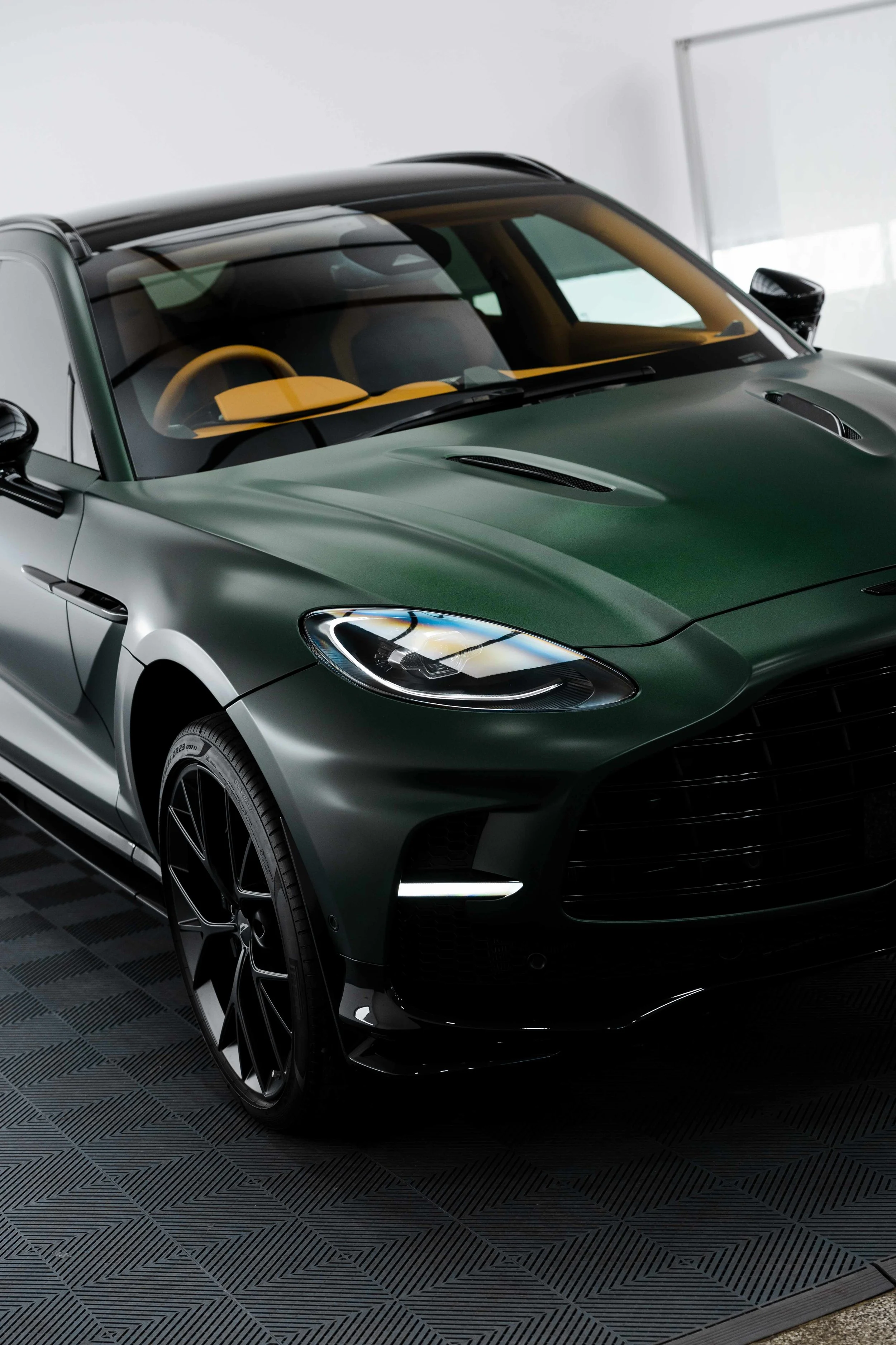 Matte green Aston Martin DBX front quarter and headlight with XPEL Stealth Paint Protection Film in Mona Vale