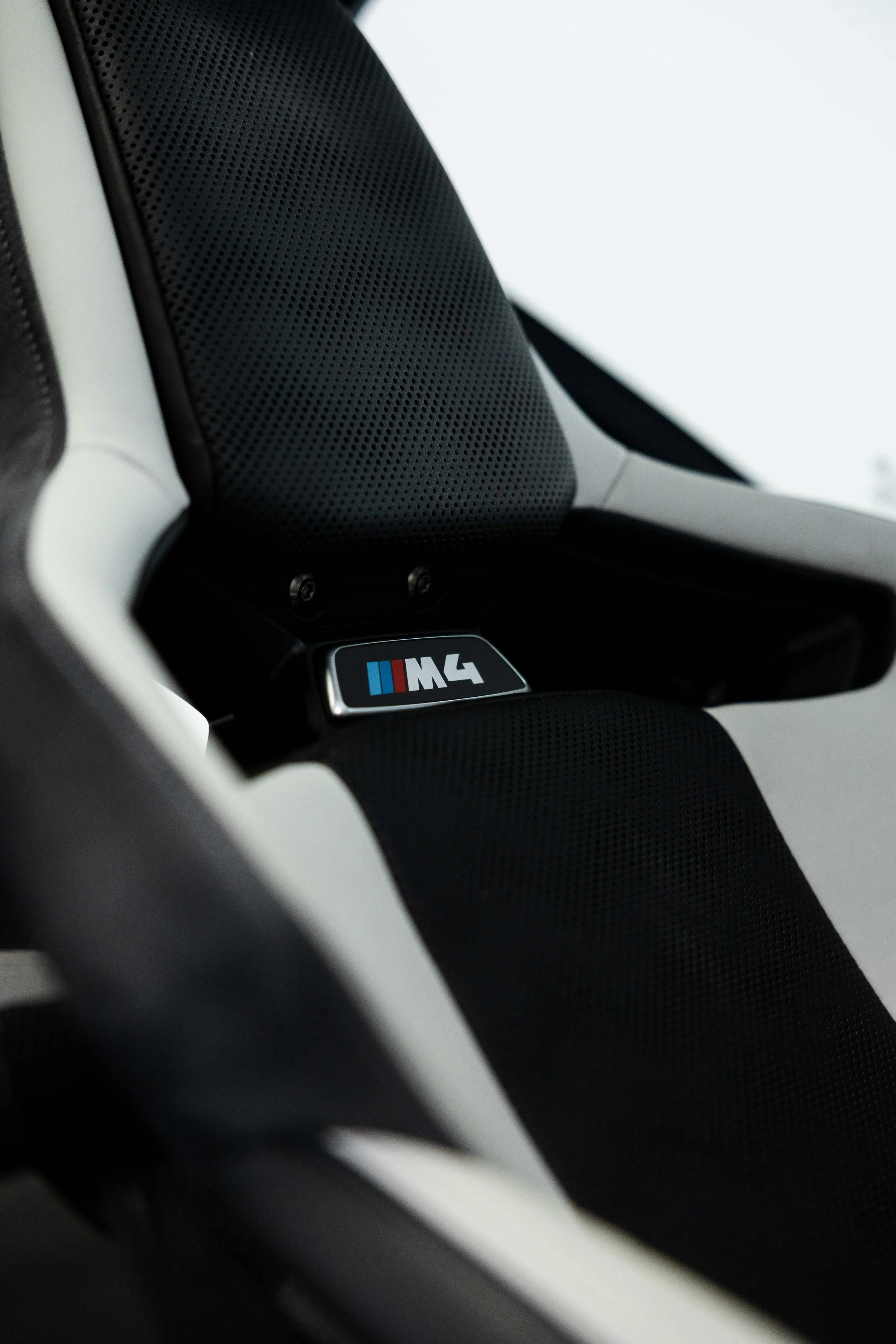 BMW M4 badge on seat headrest after interior detailing in Sydney