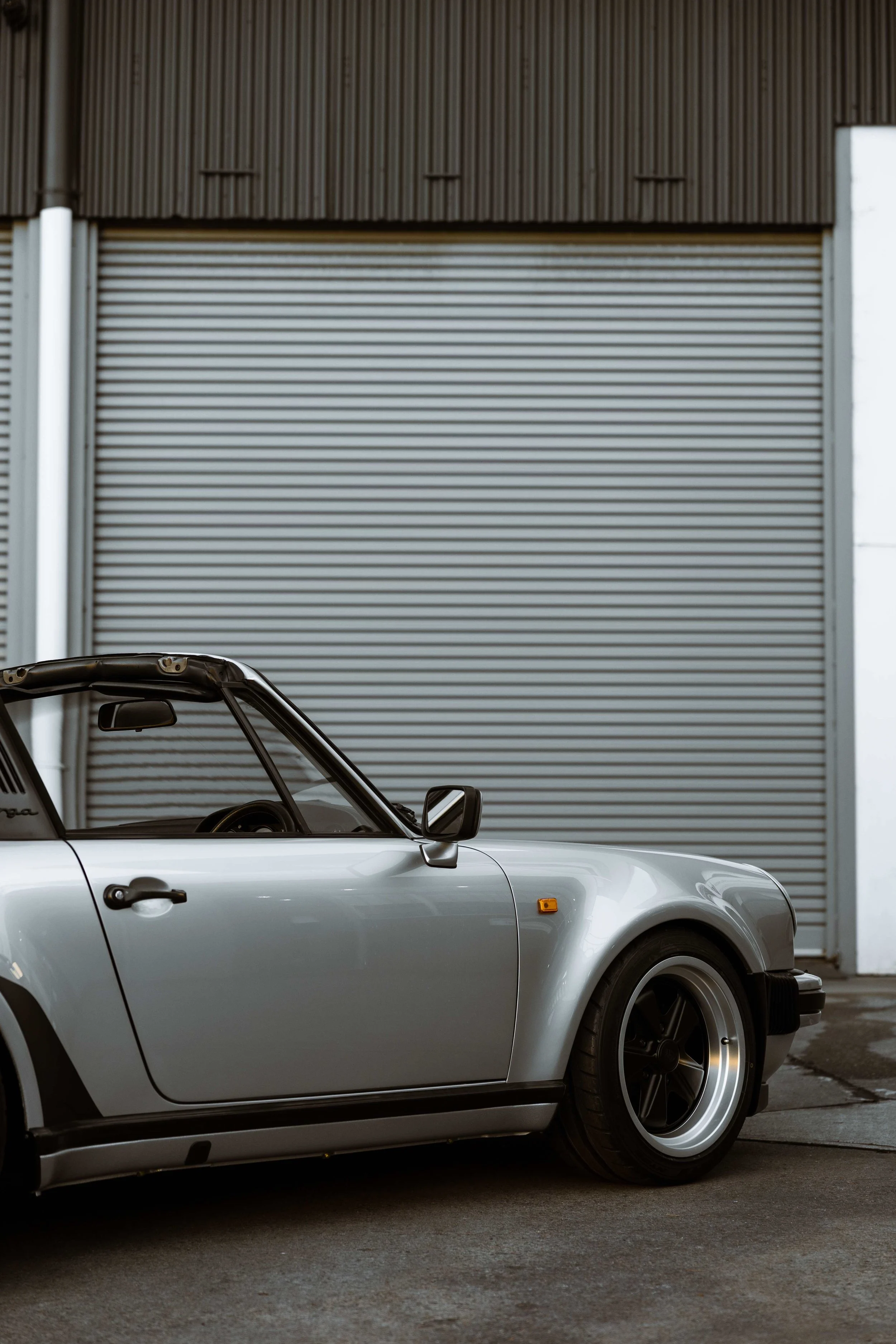 Silver 1989 Porsche 911 Carrera Targa side profile in Mona Vale
