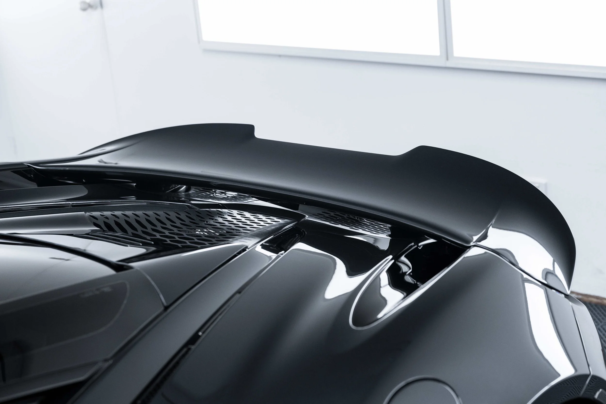 Black McLaren 750S rear spoiler and engine cover with XPEL Paint Protection Film in Sydney