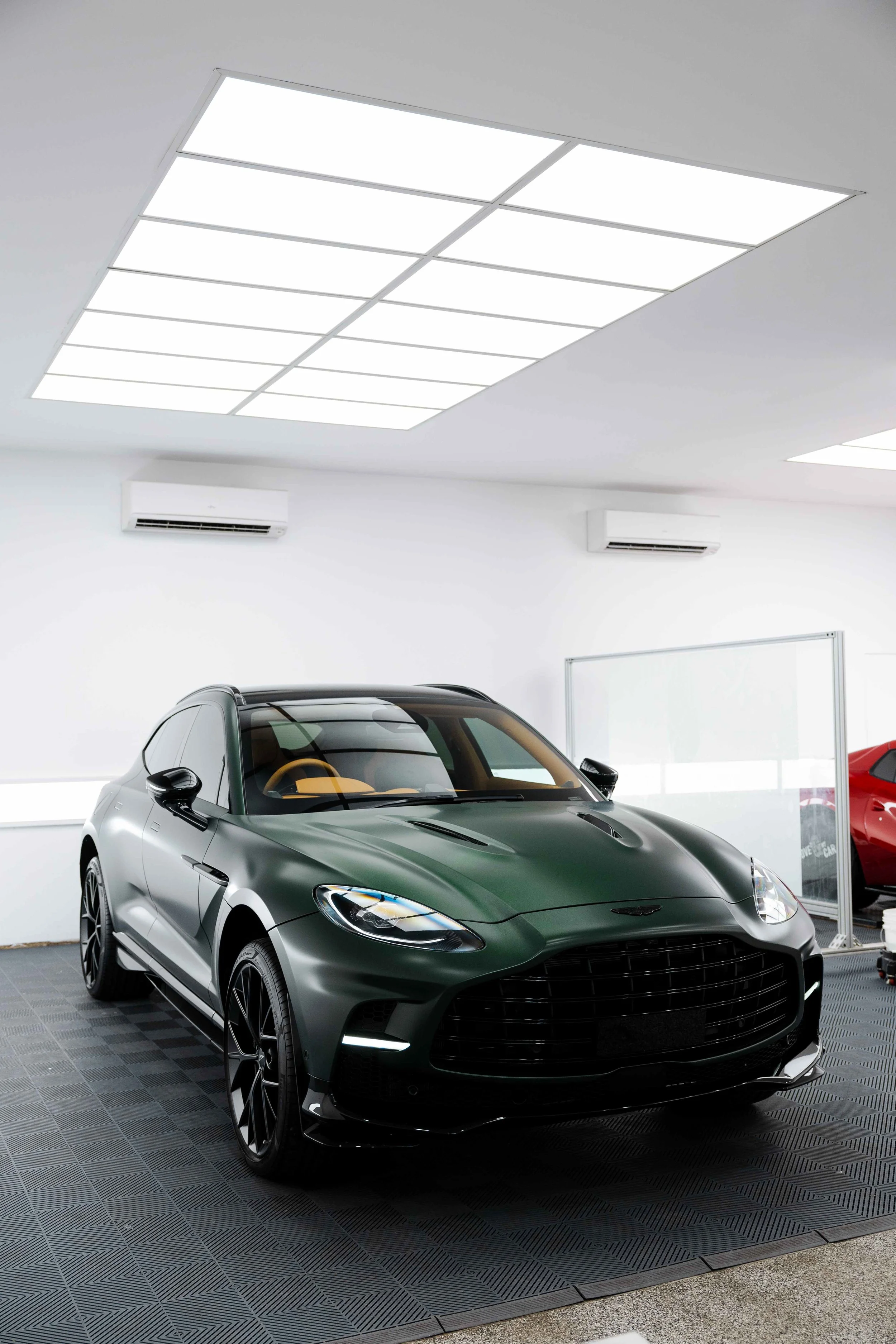 Matte green Aston Martin DBX front three quarter in studio with XPEL Stealth Paint Protection Film in Sydney