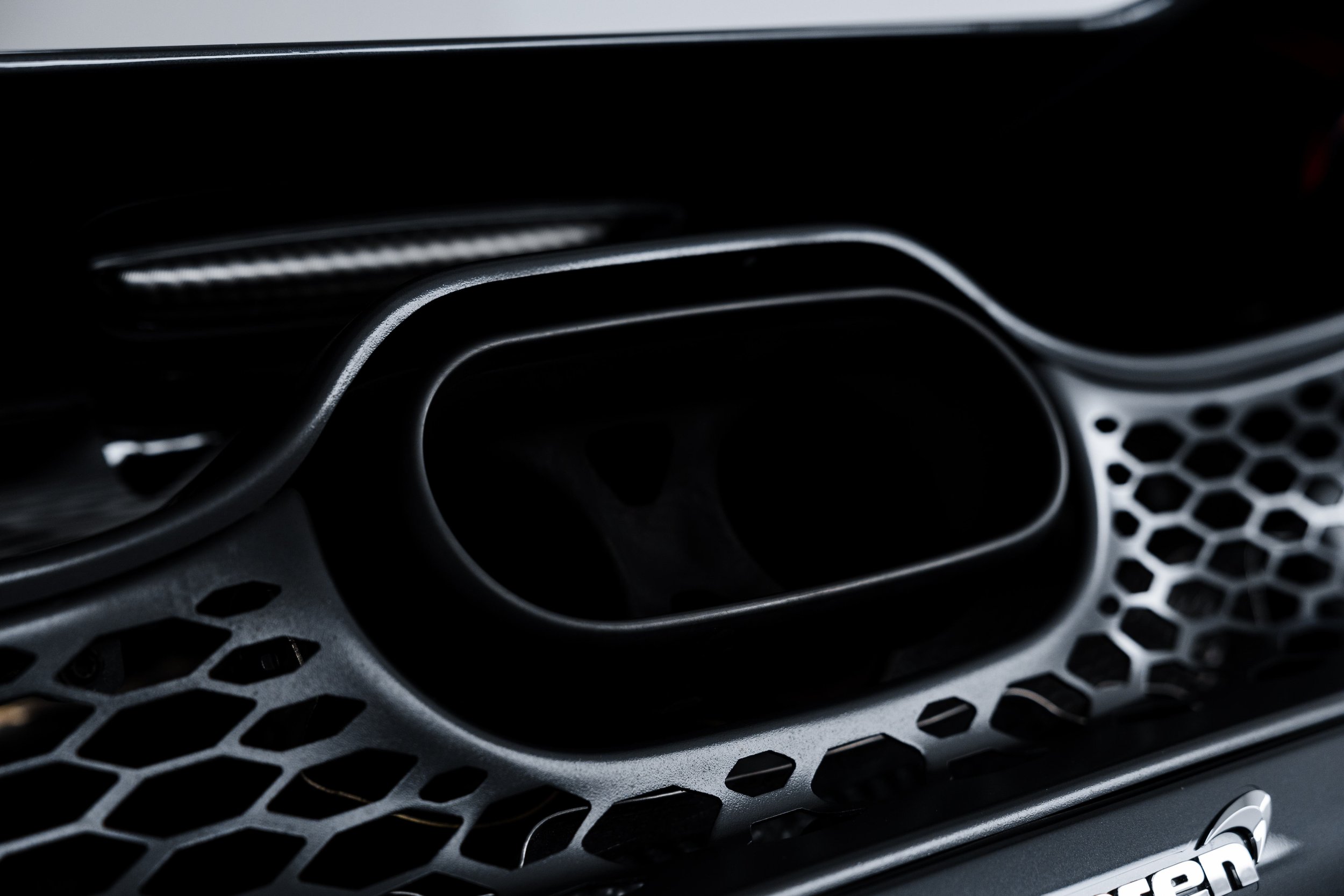 Black McLaren 750S front grille honeycomb detail with XPEL Paint Protection Film in Mona Vale