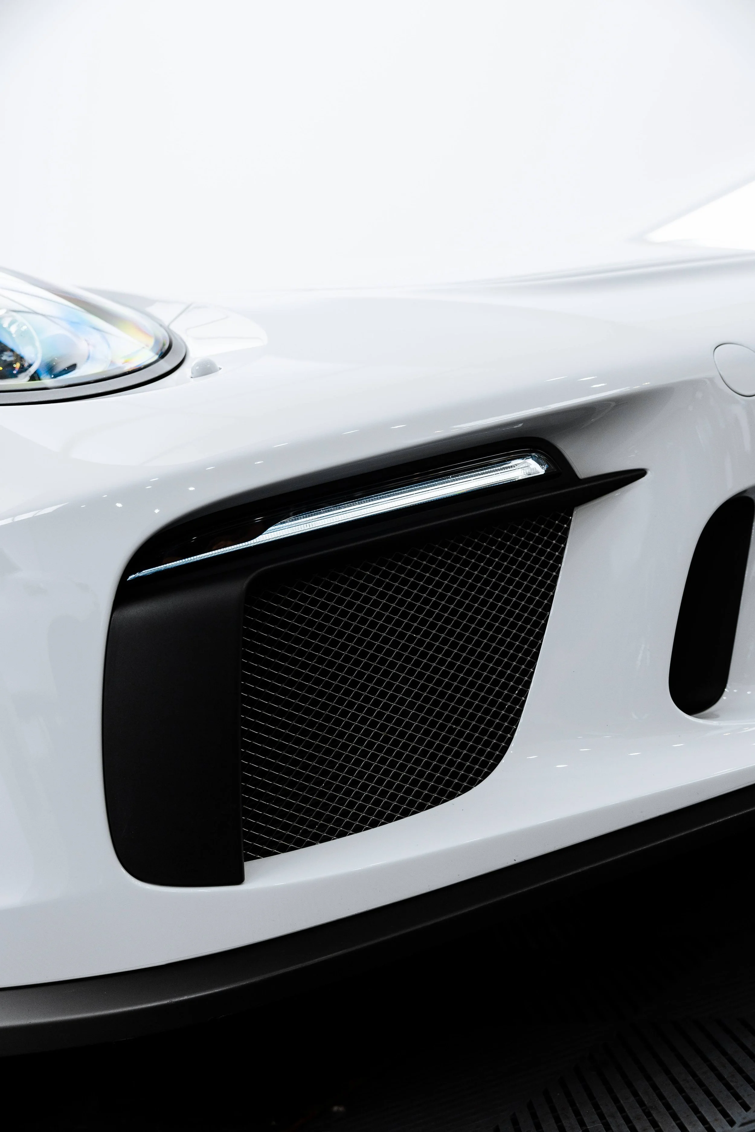 White Porsche GT3 headlight and side vent detail with XPEL Paint Protection Film in Mona Vale