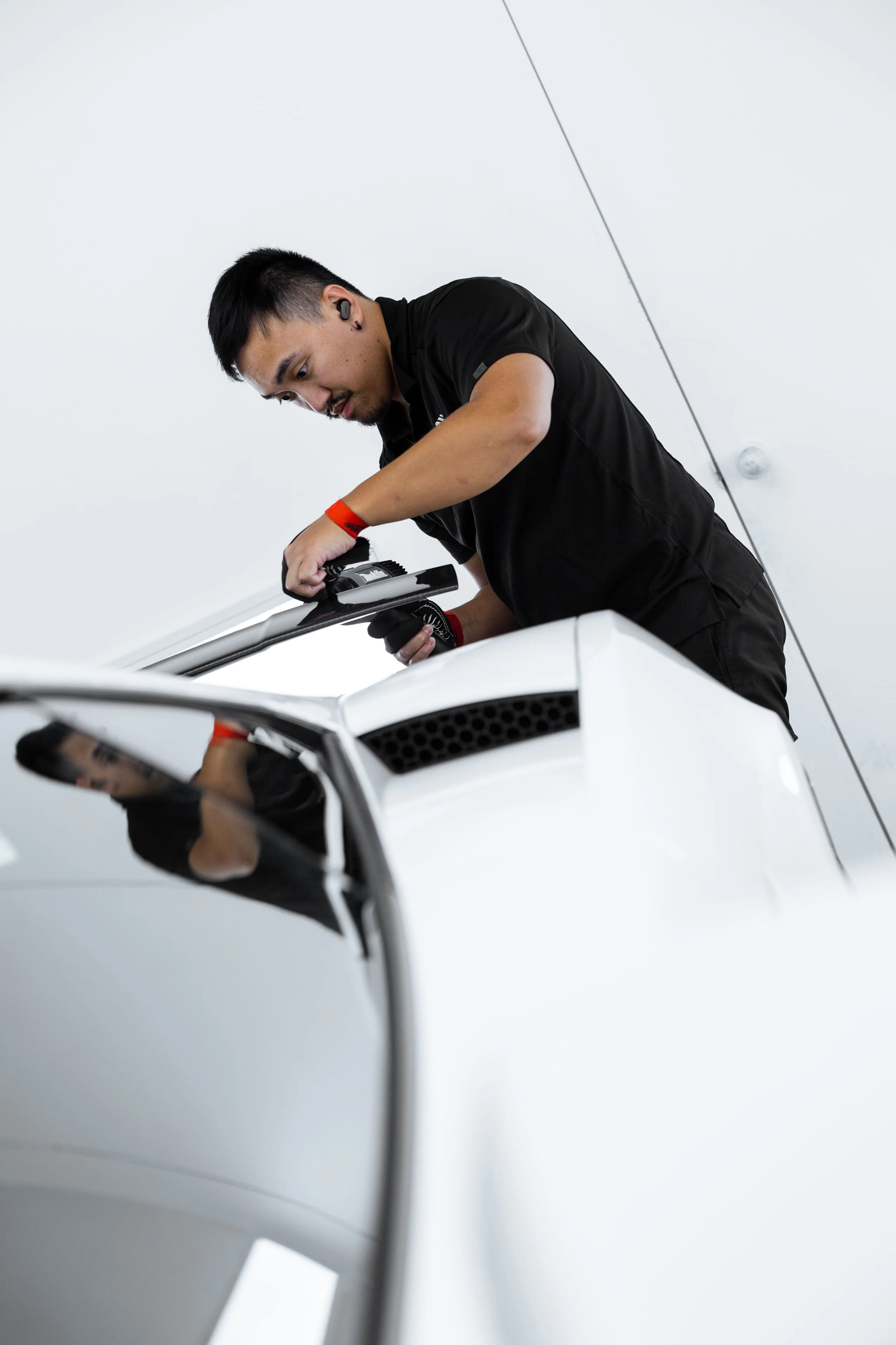 ADS technician applying Paint Protection Film to white Lamborghini Gallardo in Mona Vale workshop