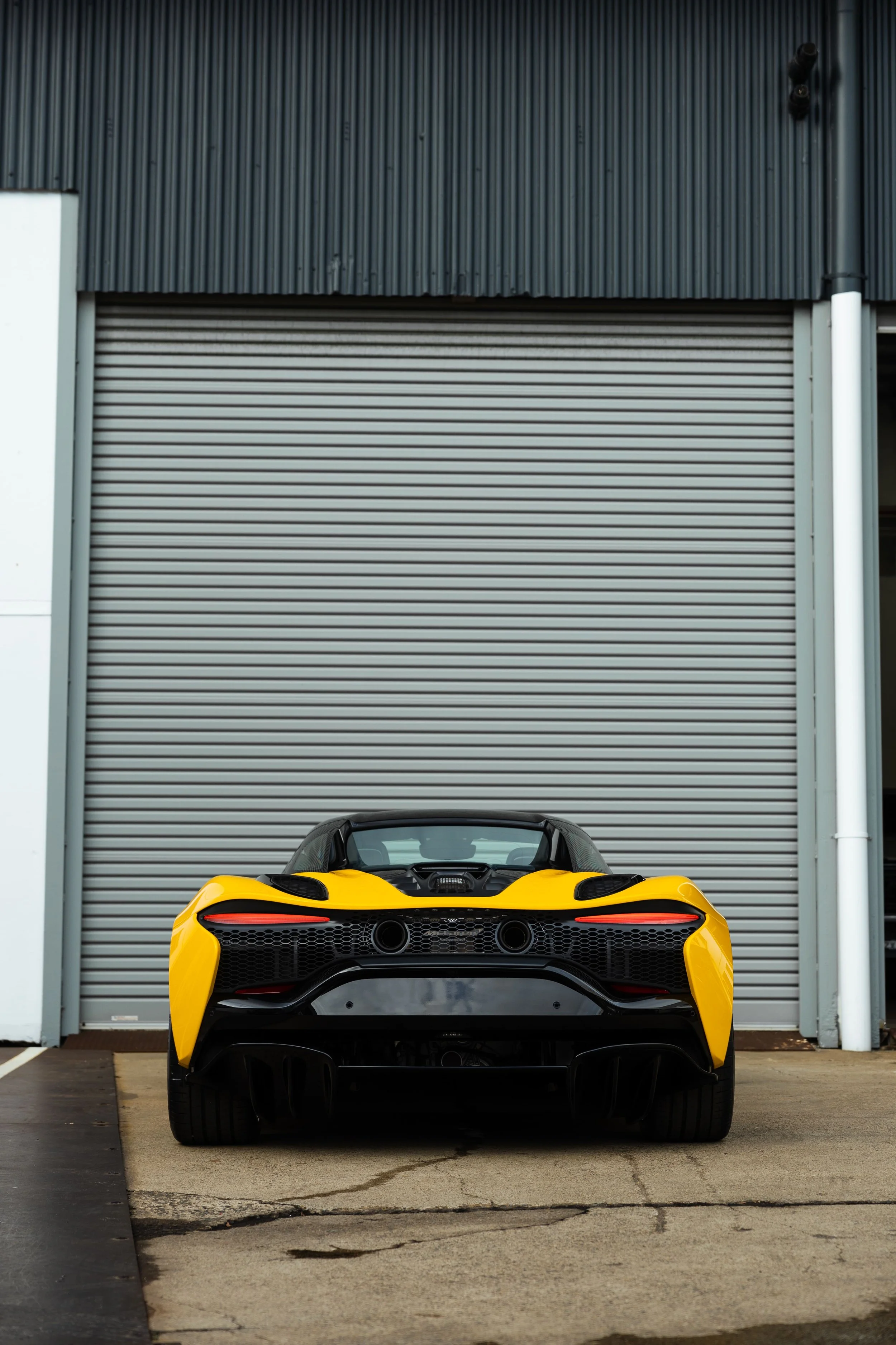 Yellow McLaren Artura rear view with full PPF protection by ADS in Mona Vale