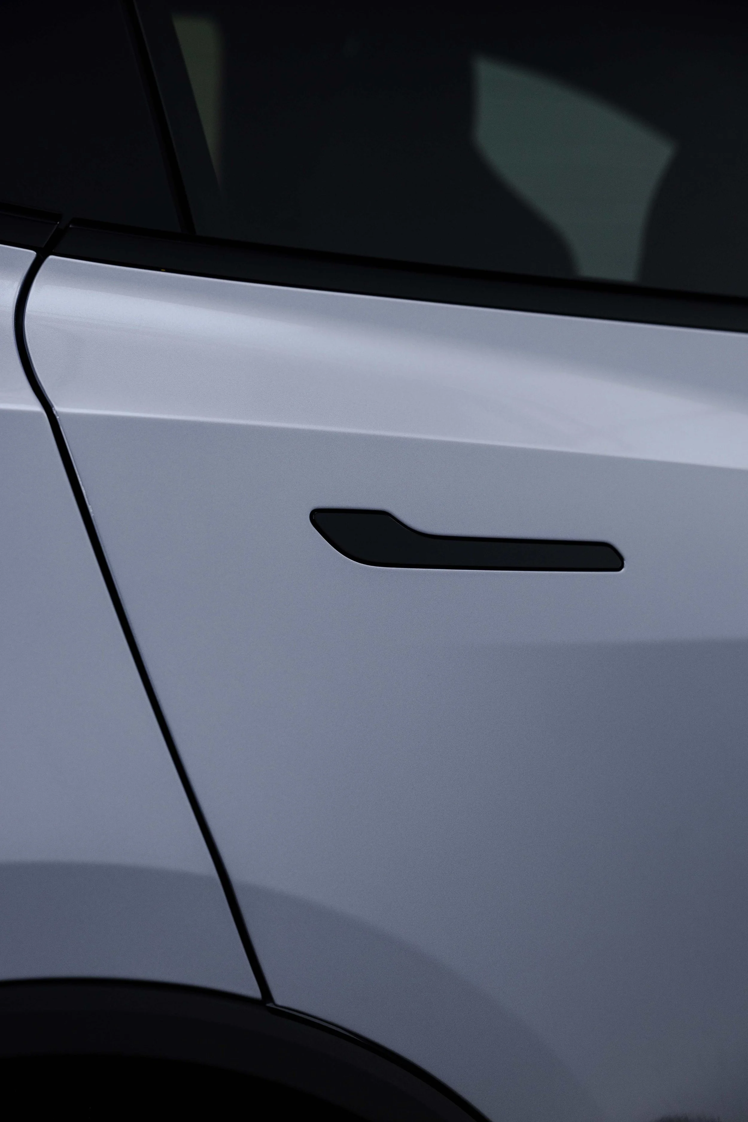 Silver Tesla Model Y door handle and panel detail with XPEL Paint Protection Film in Sydney