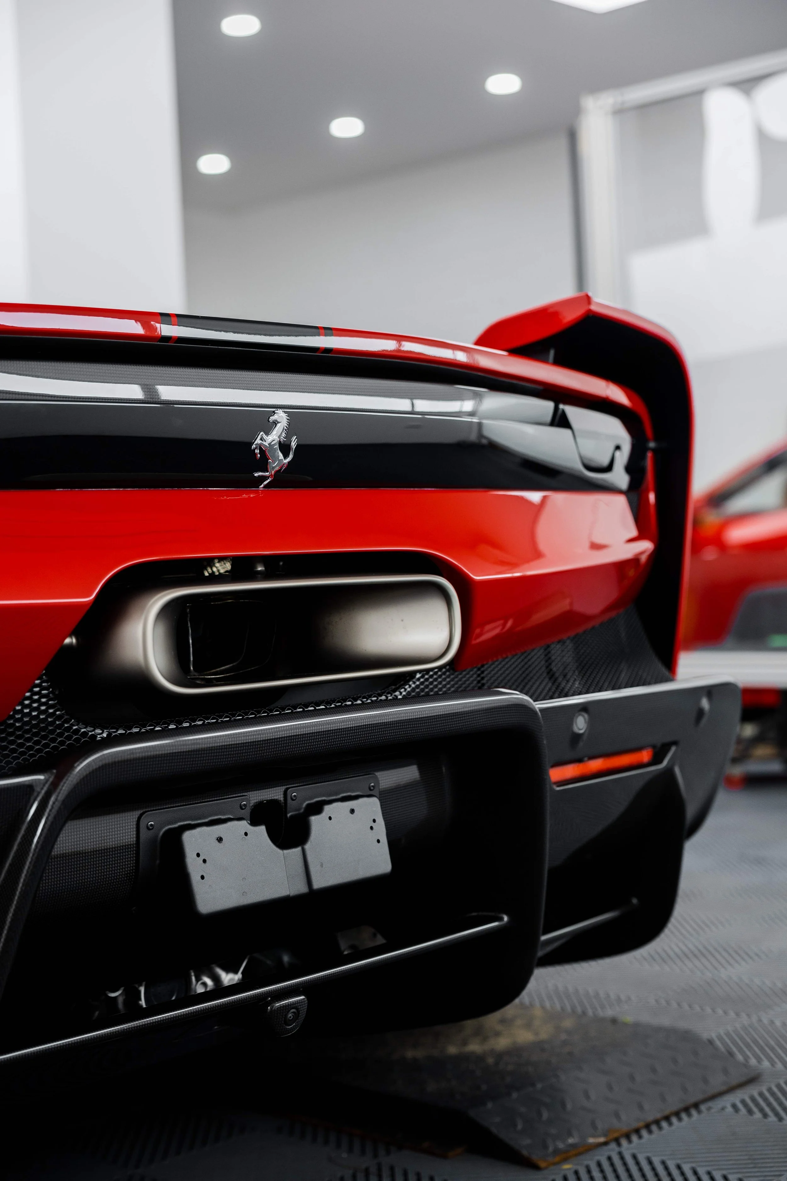 Red Ferrari 296 Speciale rear view with Prancing Horse badge and exhaust outlet in Sydney