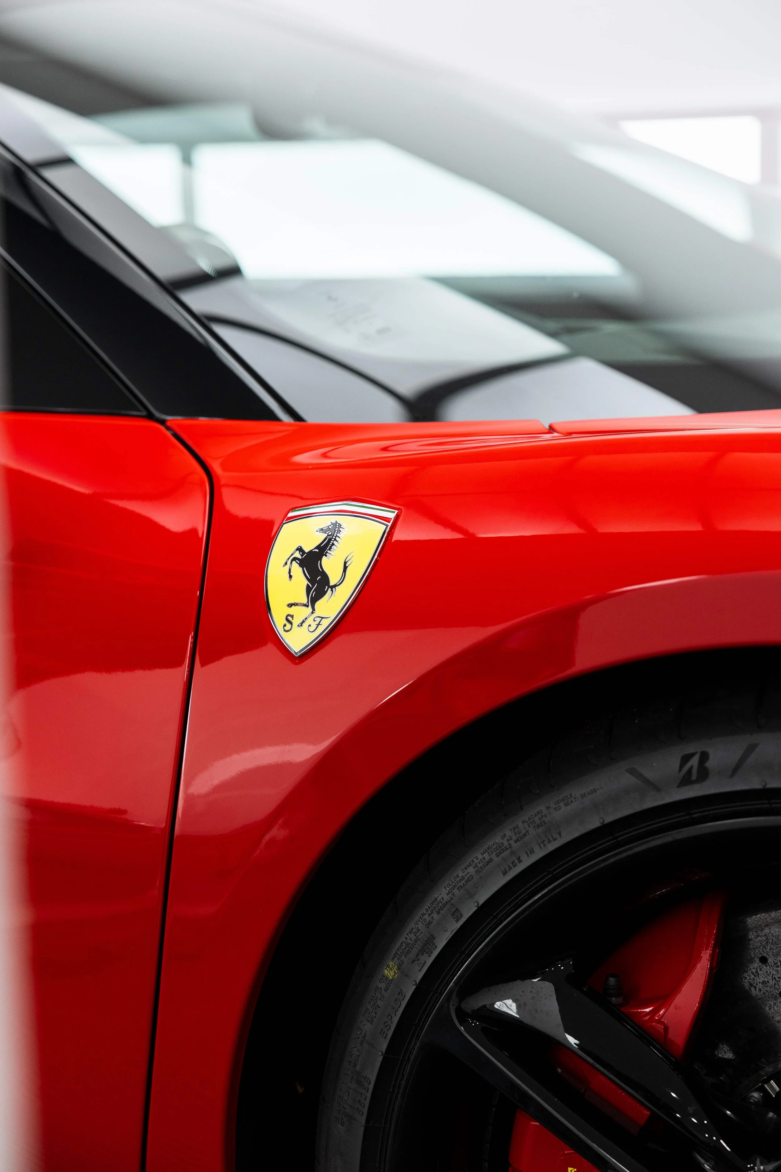 Red Ferrari 296 GTS front guard and Ferrari shield badge with XPEL Paint Protection Film in Mona Vale