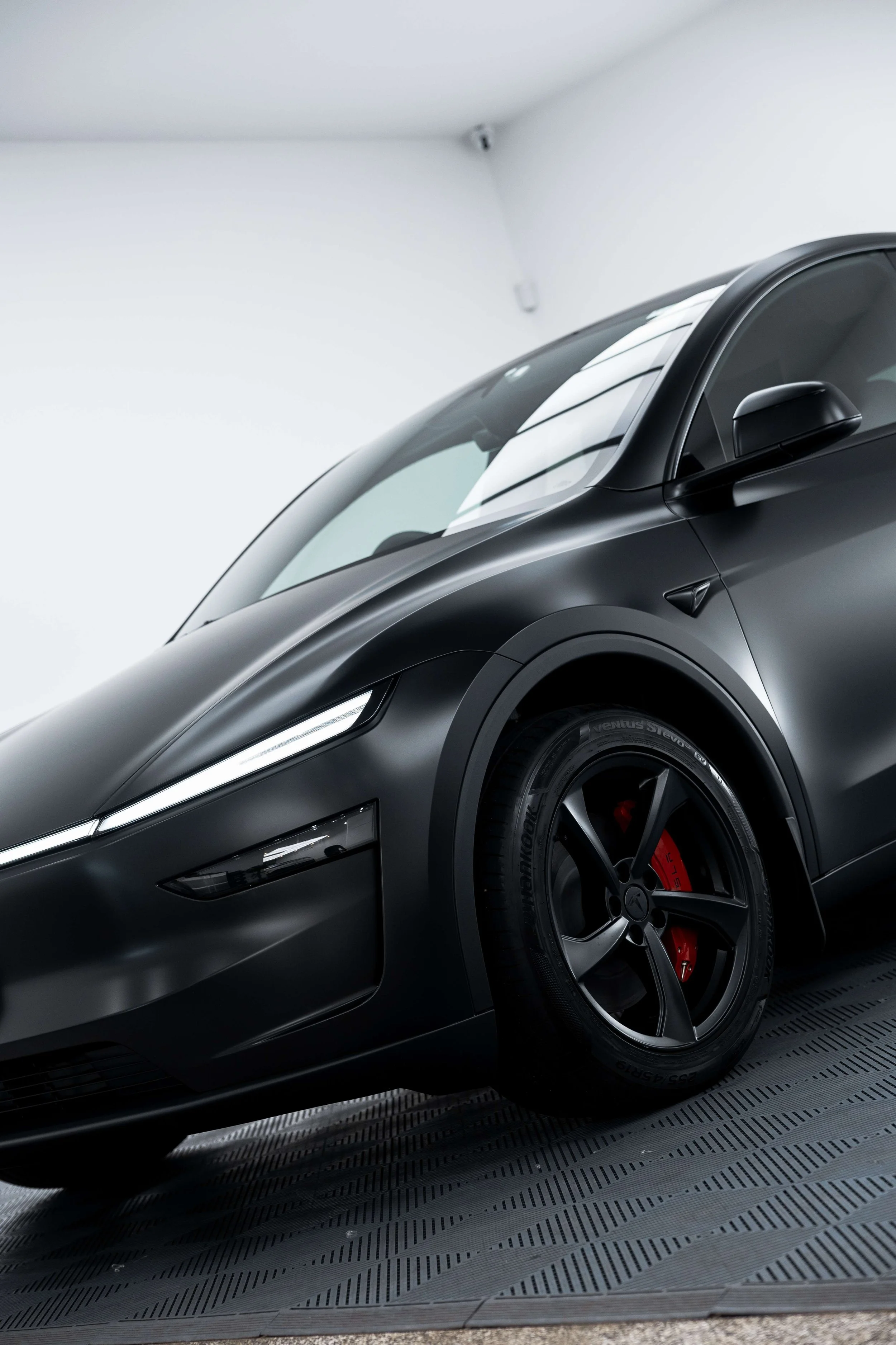 Matte black Tesla Model Y front quarter and wheel with XPEL Stealth Paint Protection Film in Sydney