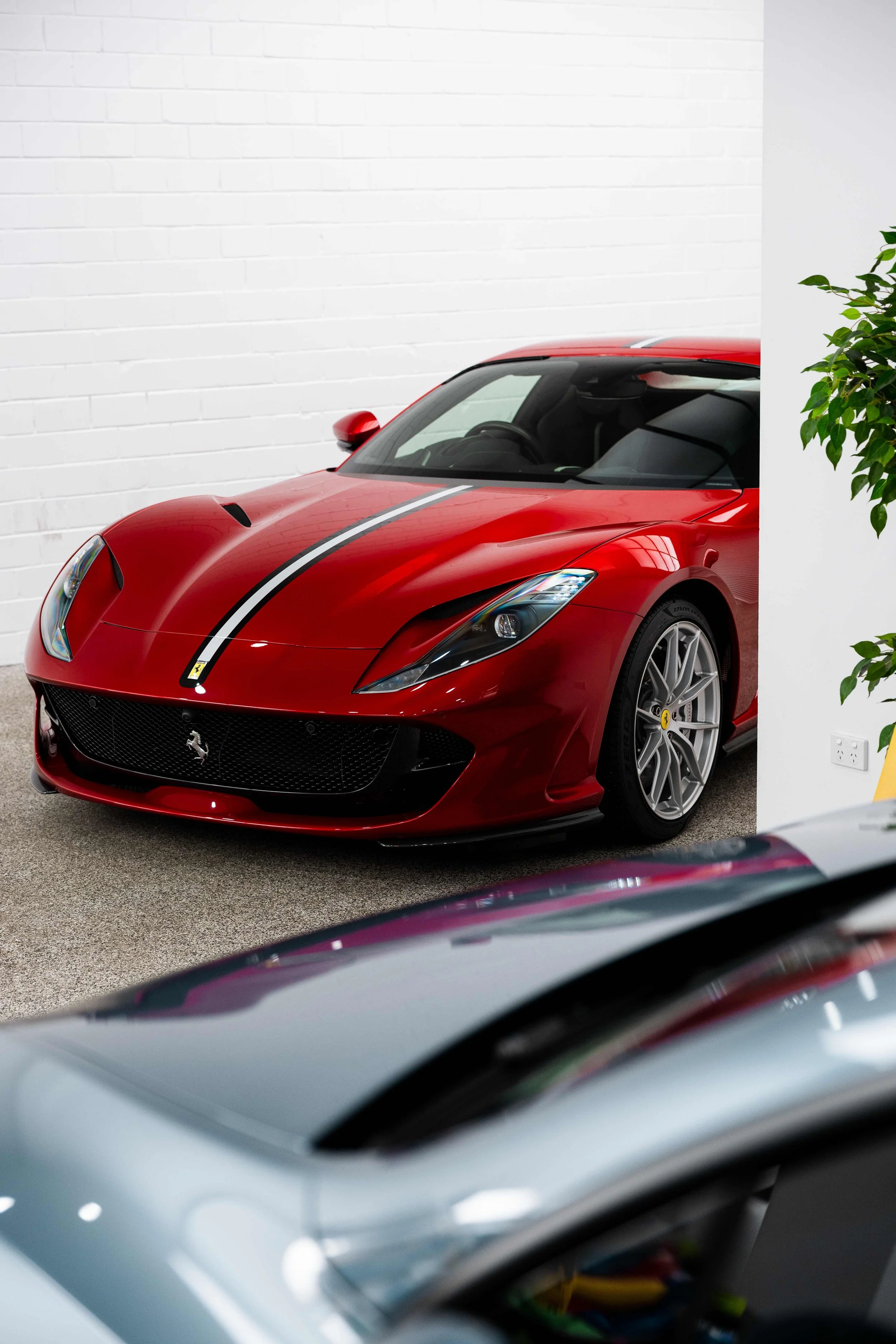 Red Ferrari 812 GTS front quarter and racing stripe with XPEL Paint Protection Film in Sydney