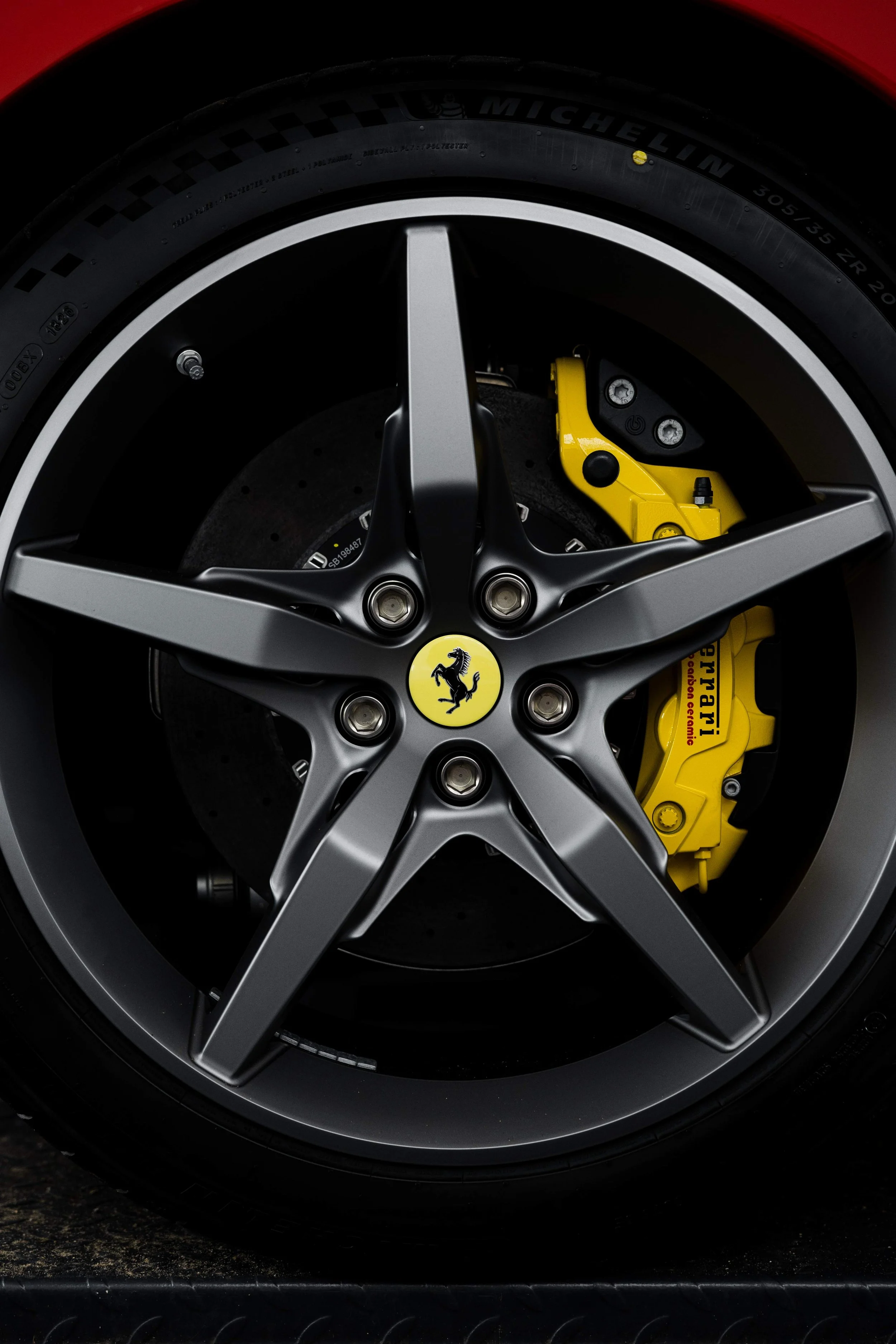 Red Ferrari 296 Speciale wheel with yellow brake caliper in Mona Vale