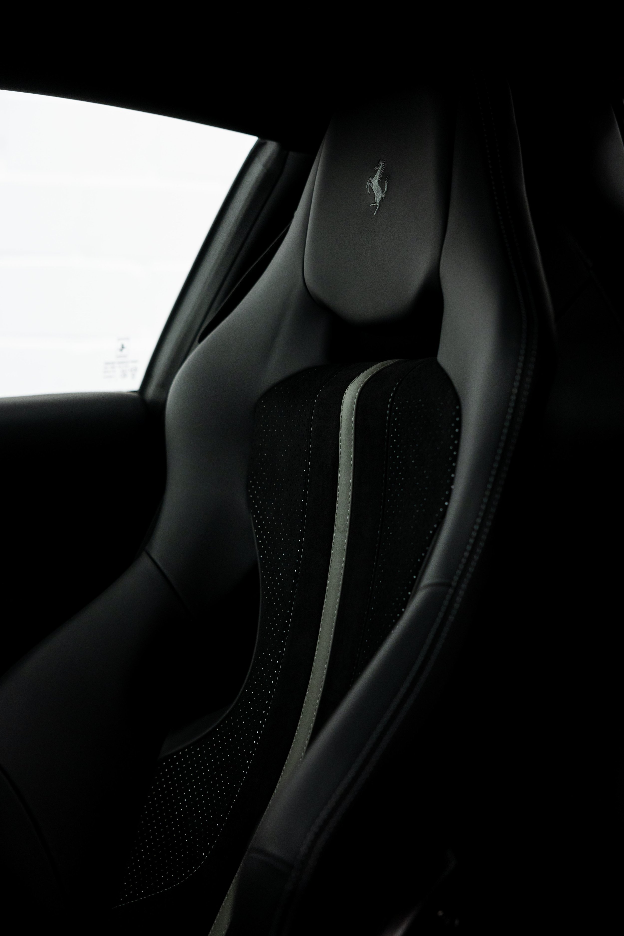 Red Ferrari 812 GTS interior detailing seat headrest with Ferrari shield in Mona Vale