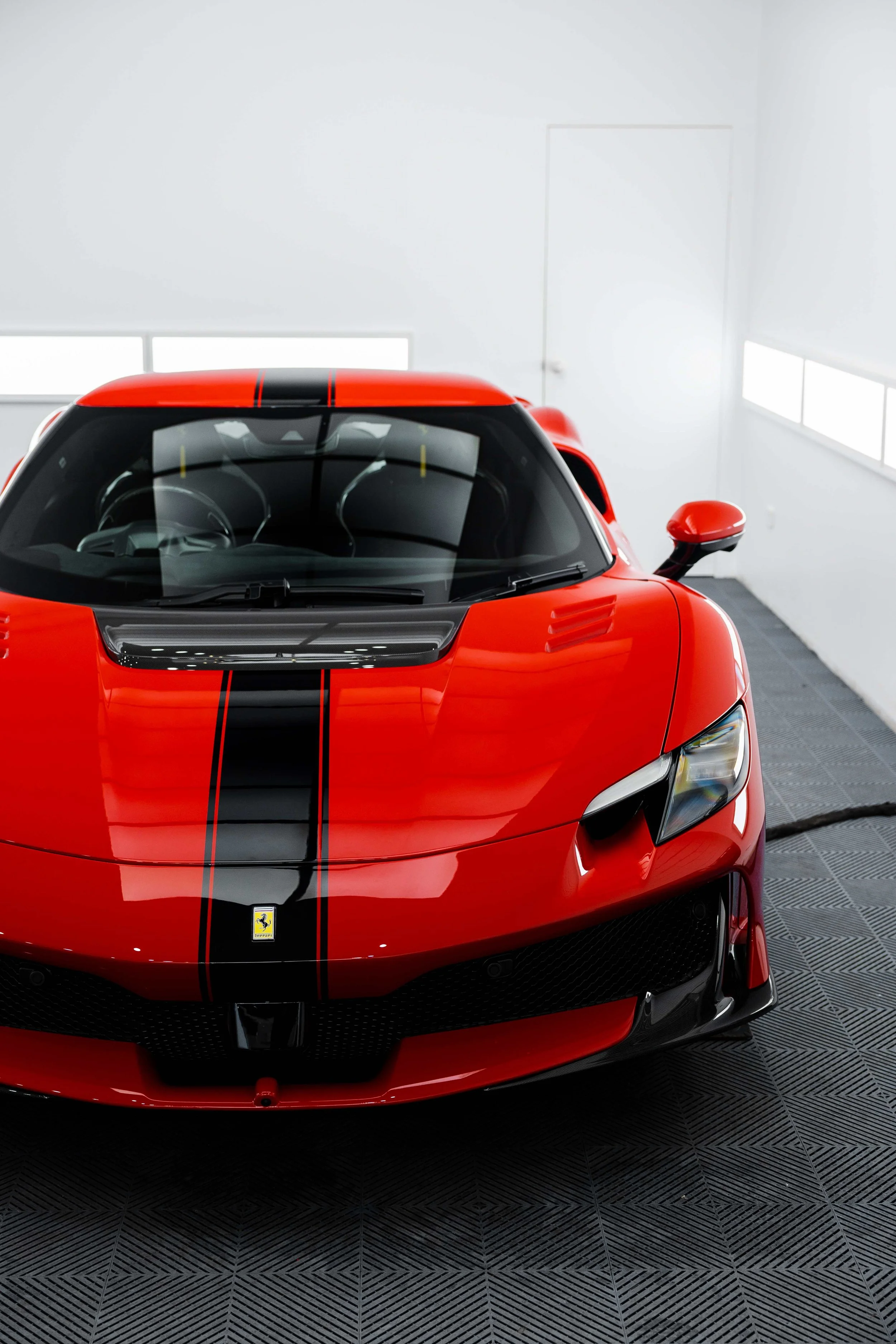 Red Ferrari 296 Speciale front view with black racing stripe and bonnet with XPEL Paint Protection Film in Mona Vale