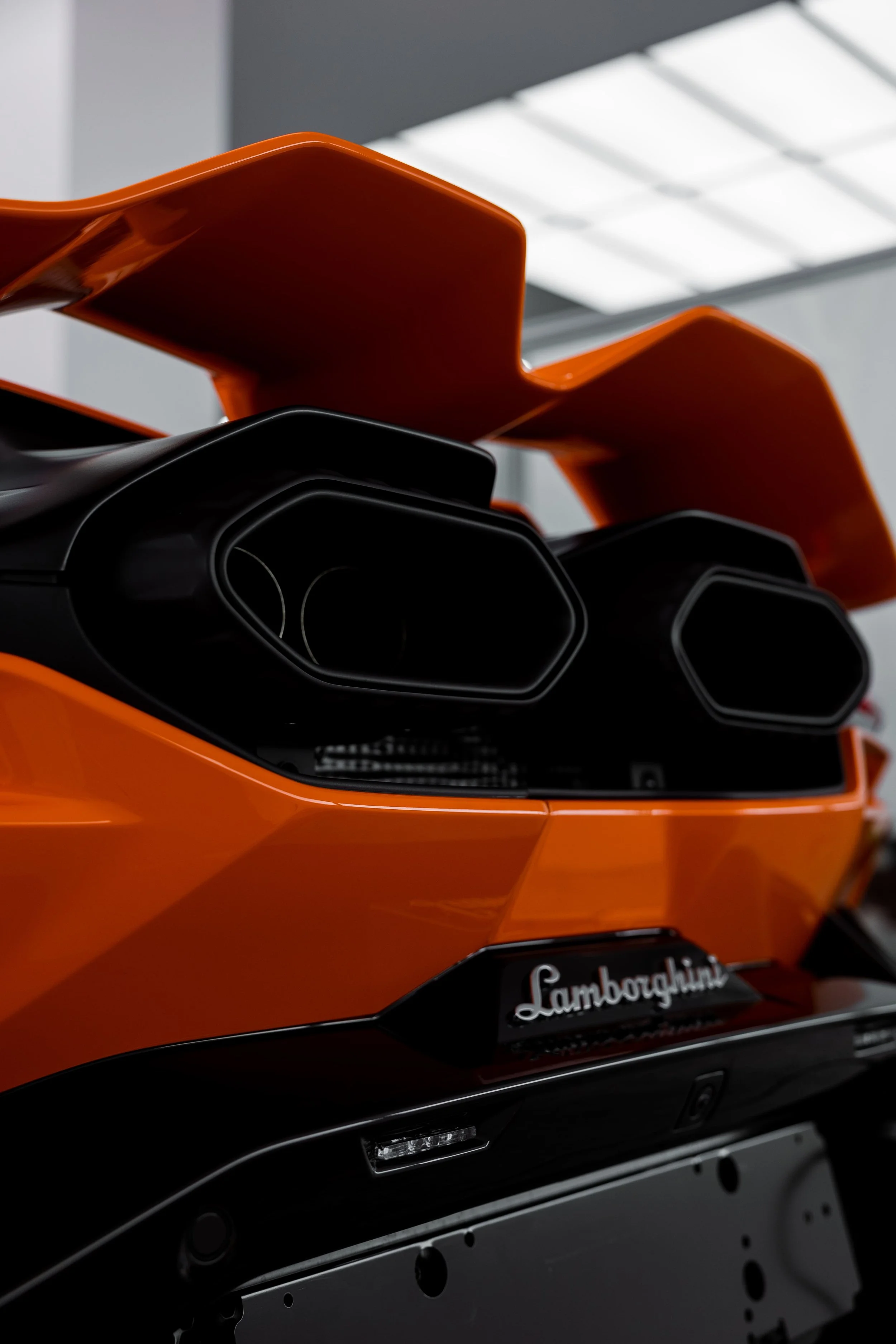 Orange Lamborghini Revuelto rear exhaust and spoiler detail with full PPF by ADS in Mona Vale