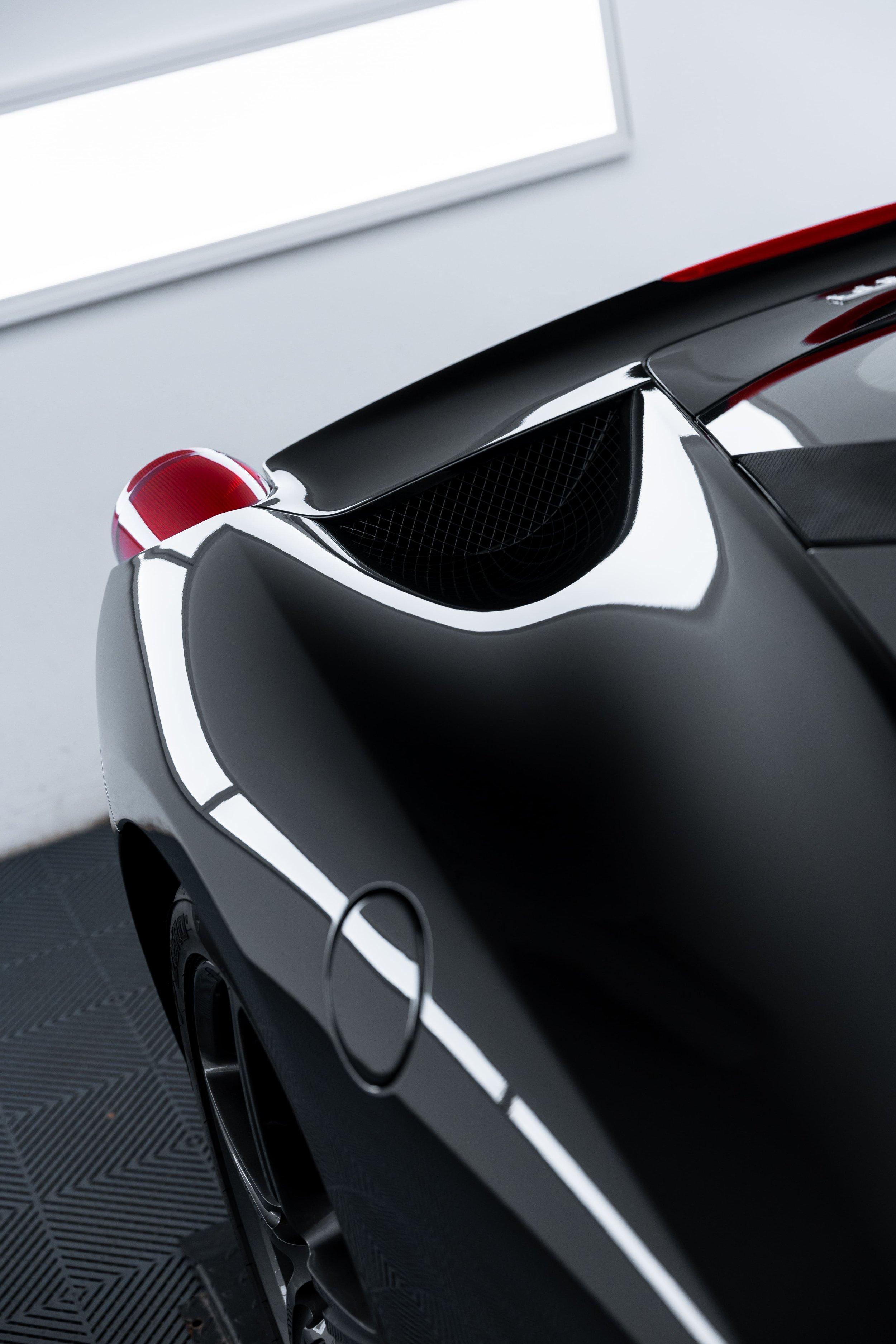 Rear quarter detail of black Ferrari 458 with full PPF protection by ADS in Mona Vale