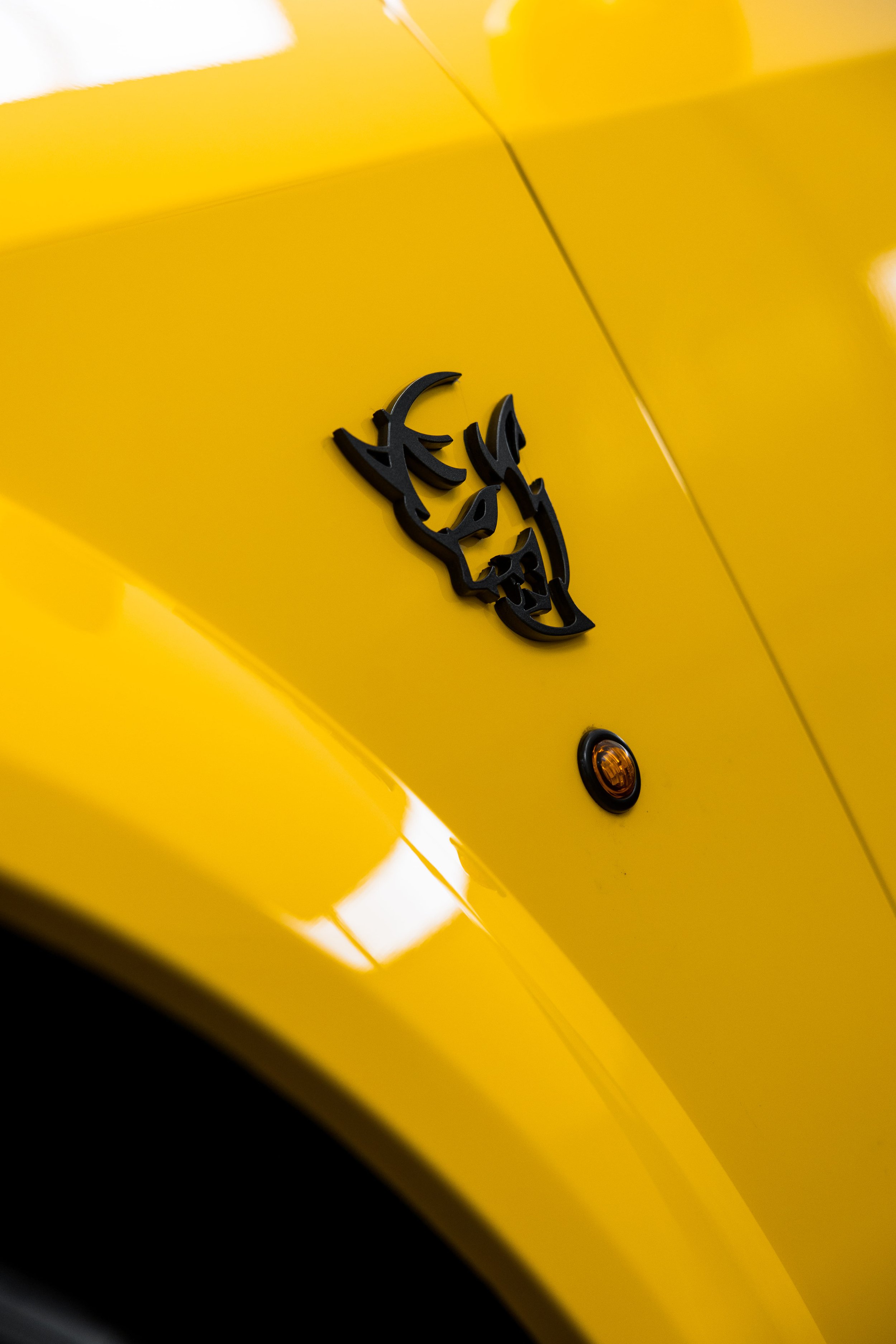 Close-up of yellow Dodge Challenger SRT Demon fender badge with PPF by ADS in Mona Vale