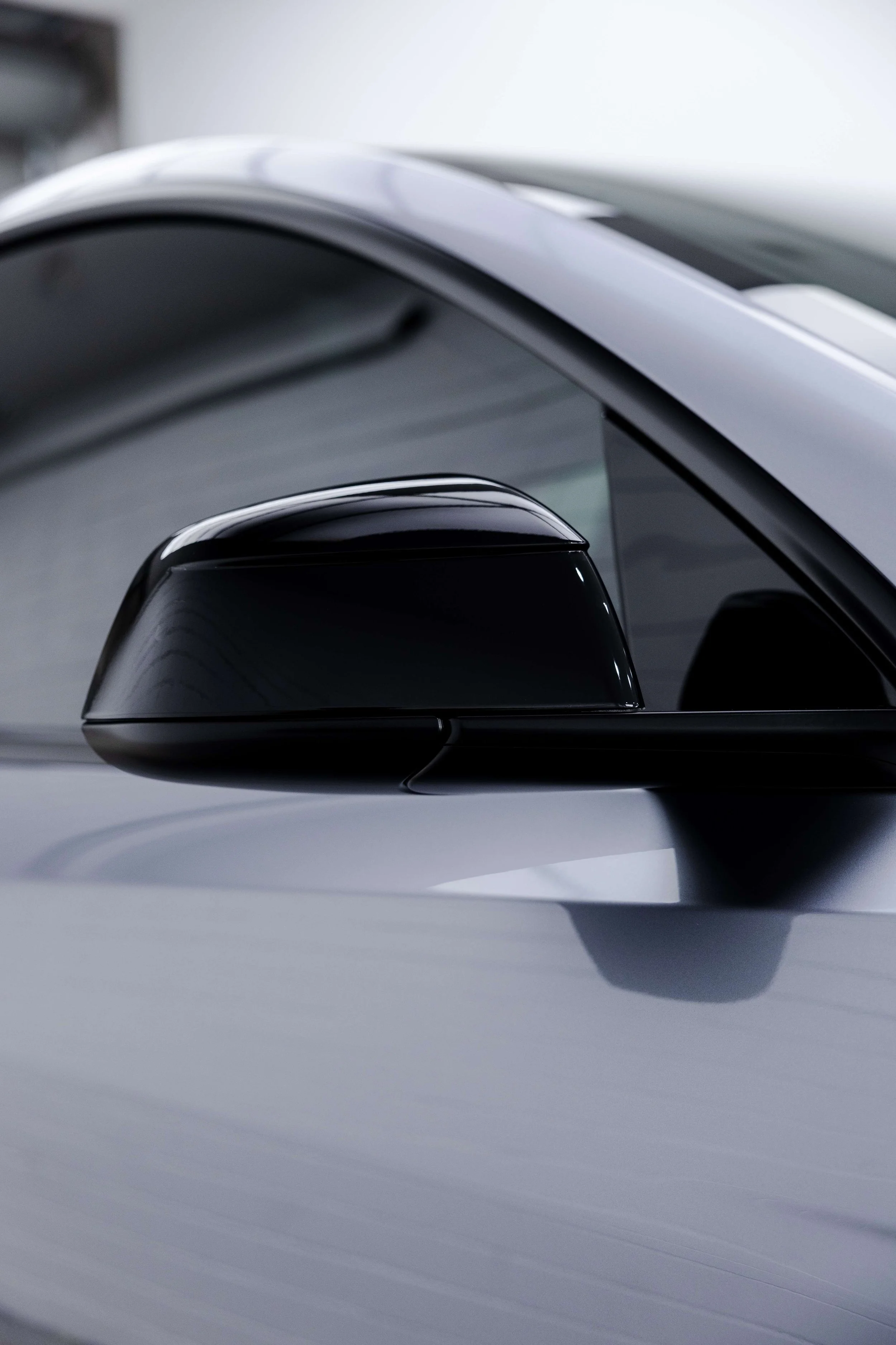 Silver Tesla Model Y door mirror and roofline with XPEL Paint Protection Film in Sydney