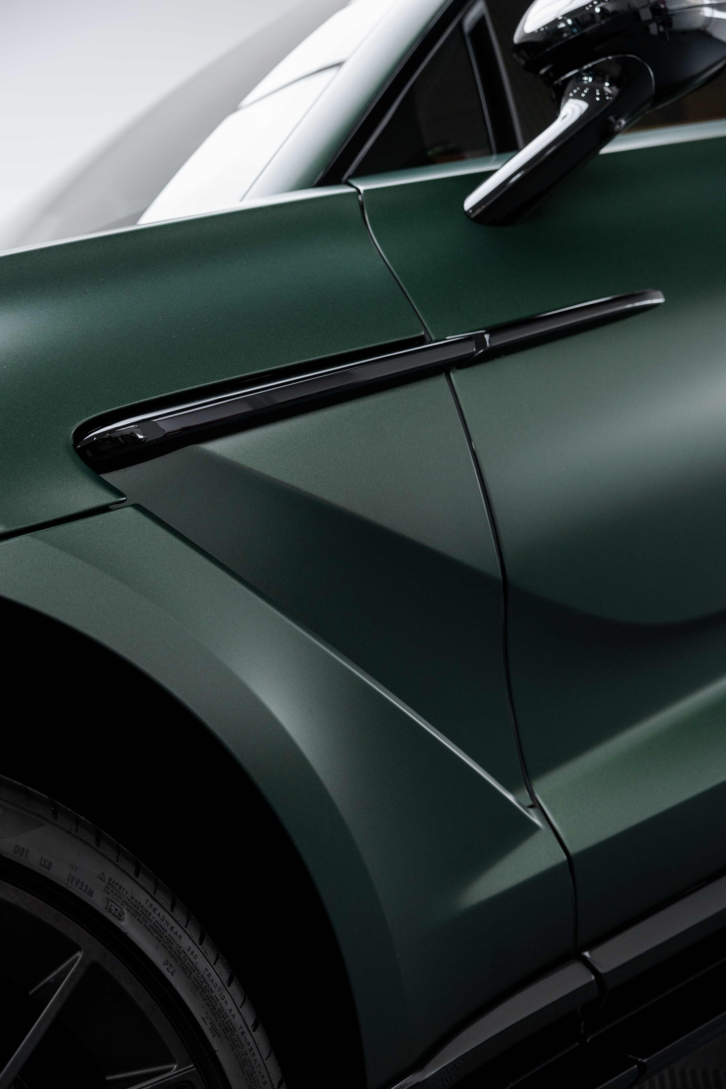 Matte green Aston Martin DBX door mirror and front guard with XPEL Stealth Paint Protection Film in Sydney