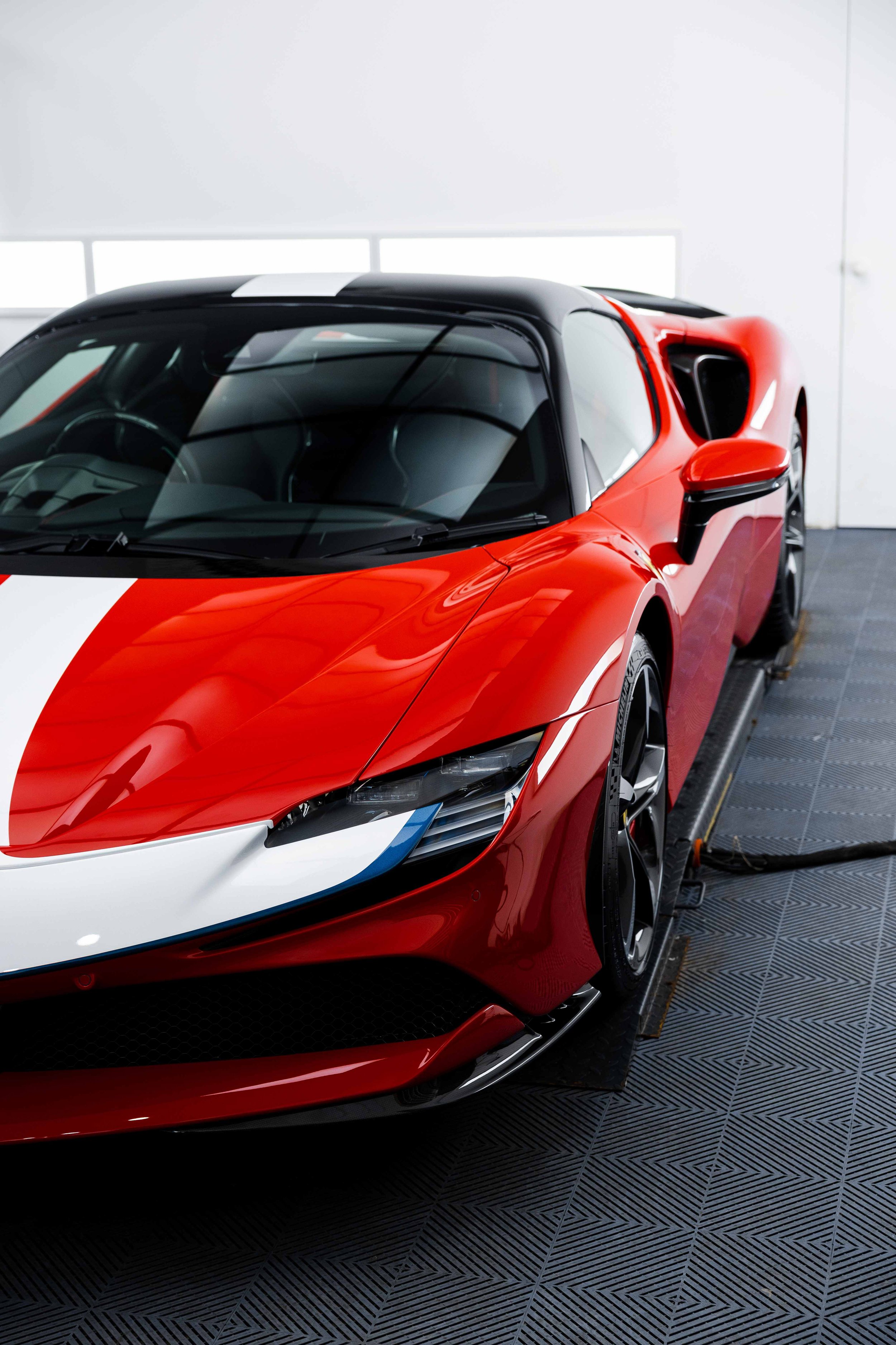 Red Ferrari SF90 Spyder front three quarter with white stripe and XPEL Paint Protection Film in Sydney