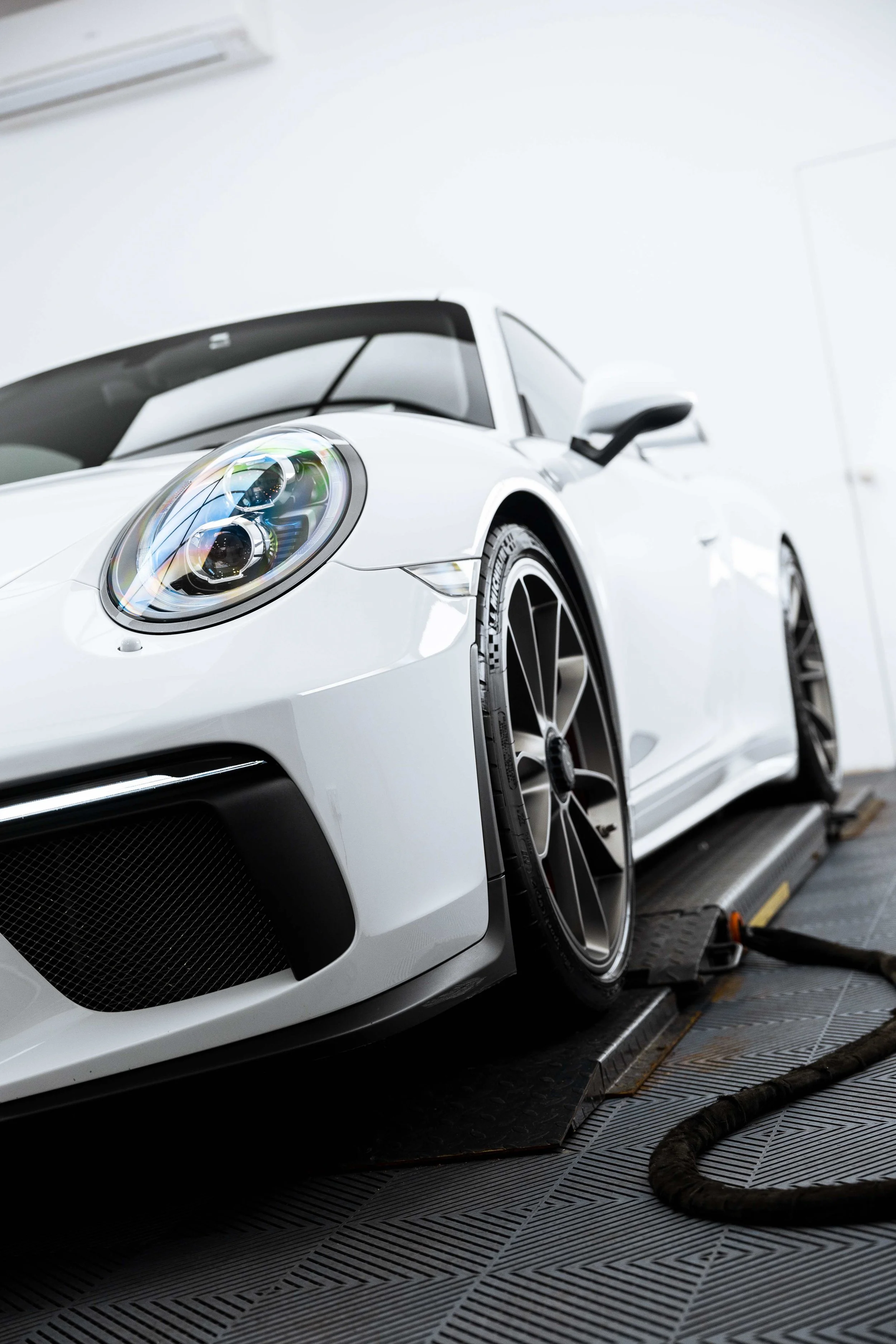 White Porsche GT3 front quarter and headlight with XPEL Paint Protection Film in Sydney