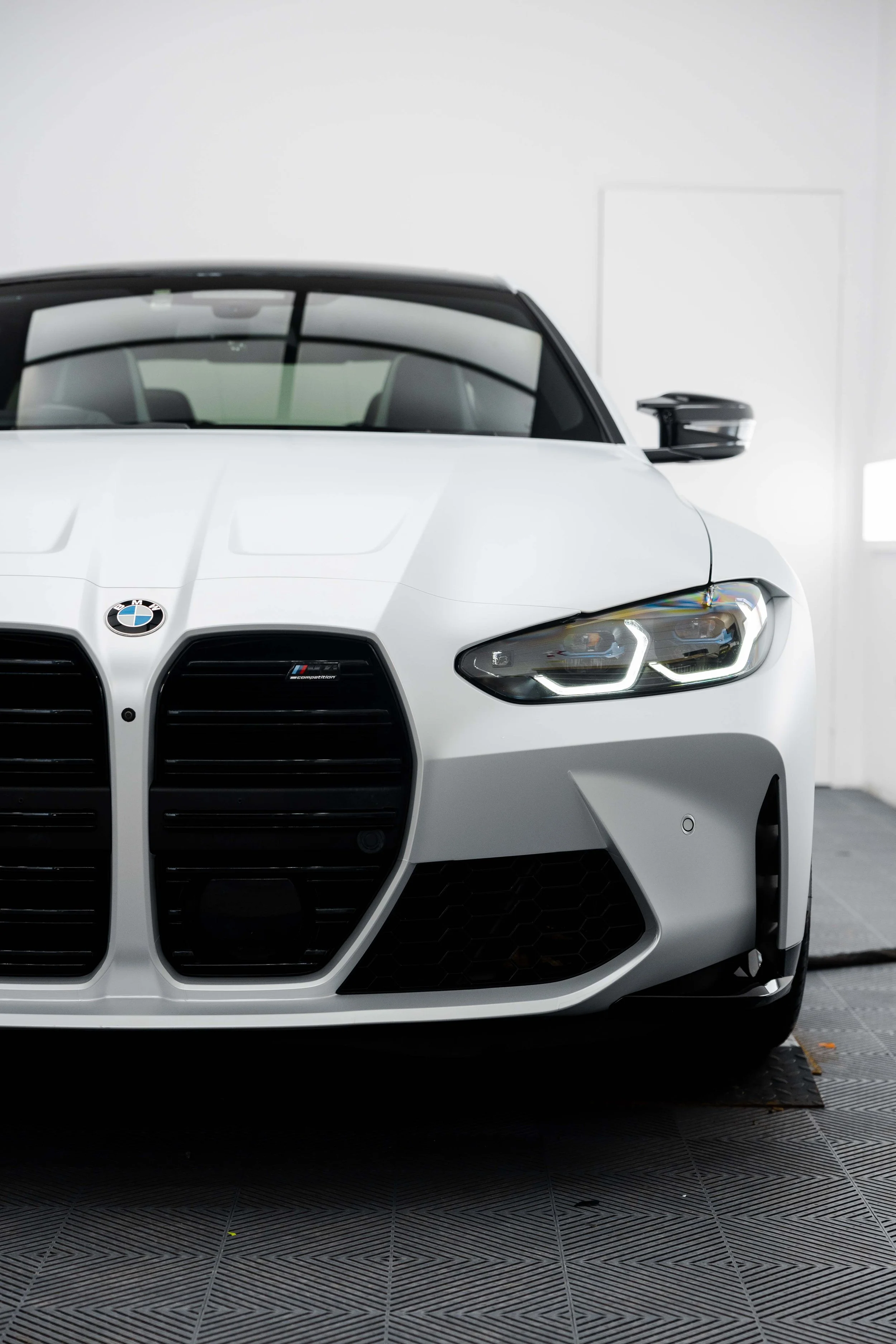 White BMW M4 Competition front grille and headlight with XPEL Paint Protection Film in Sydney