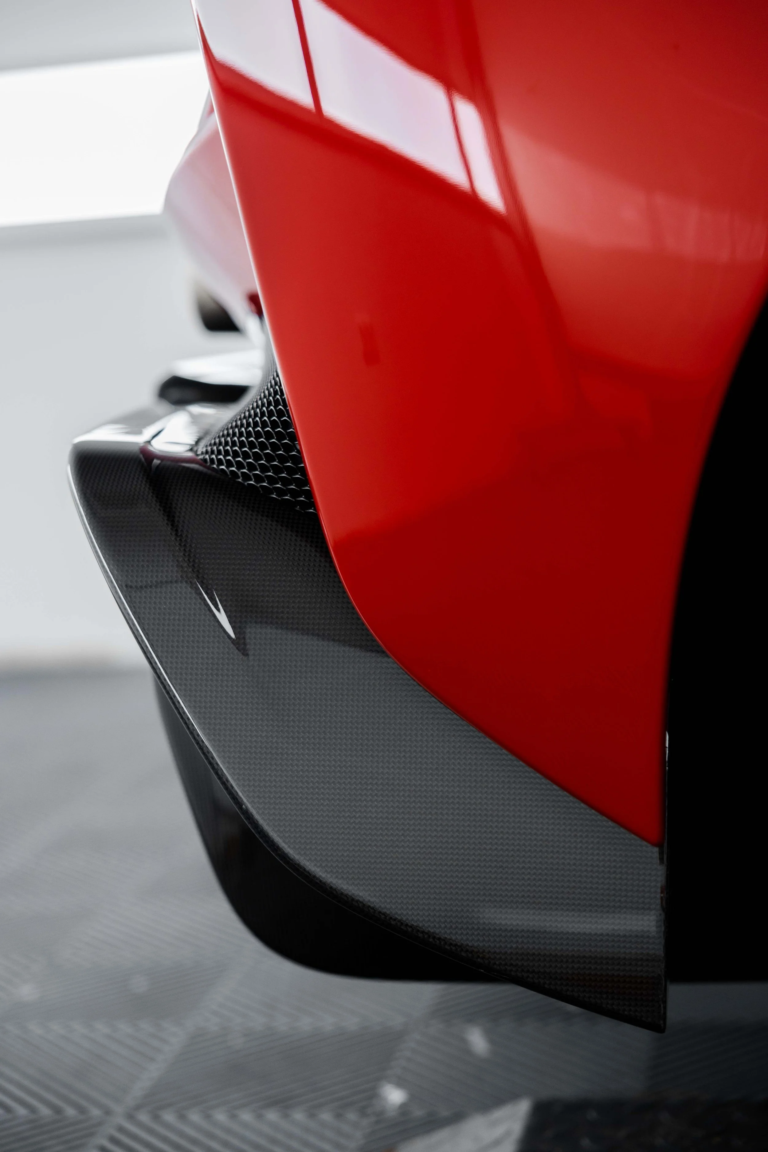 Red Ferrari 296 Speciale front guard and carbon splitter detail with XPEL Paint Protection Film in Sydney