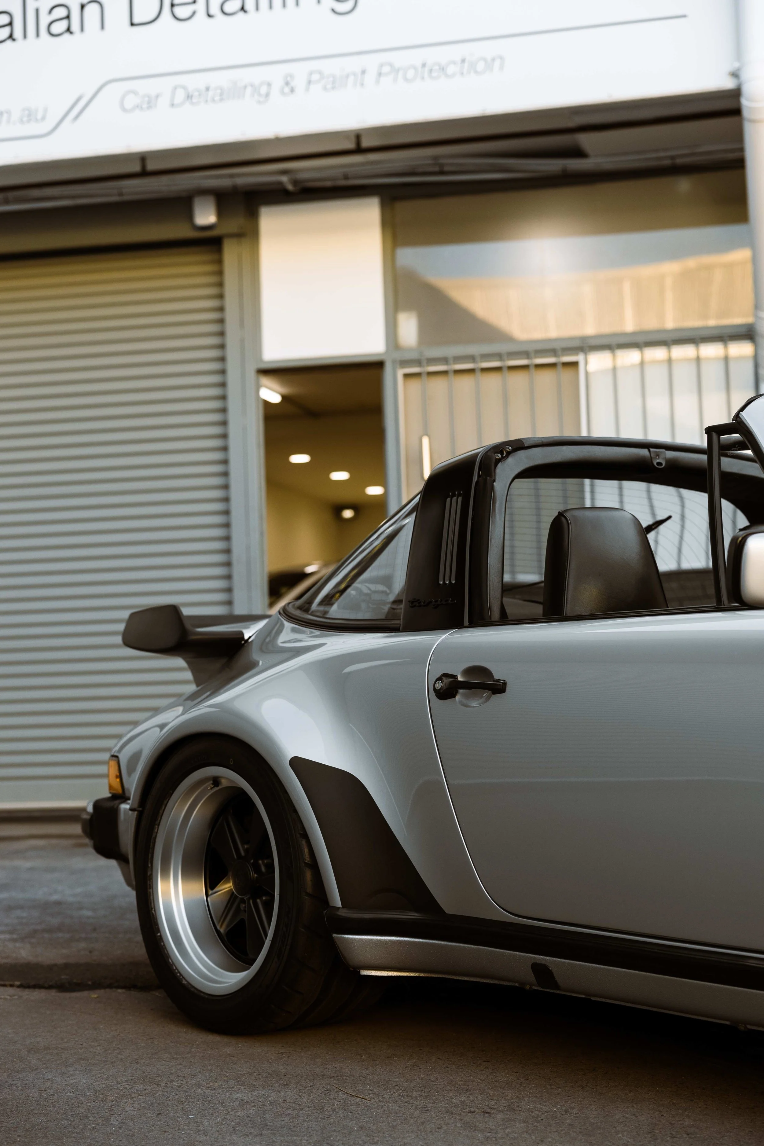 Silver 1989 Porsche 911 Carrera Targa side profile and wide body guard in Mona Vale