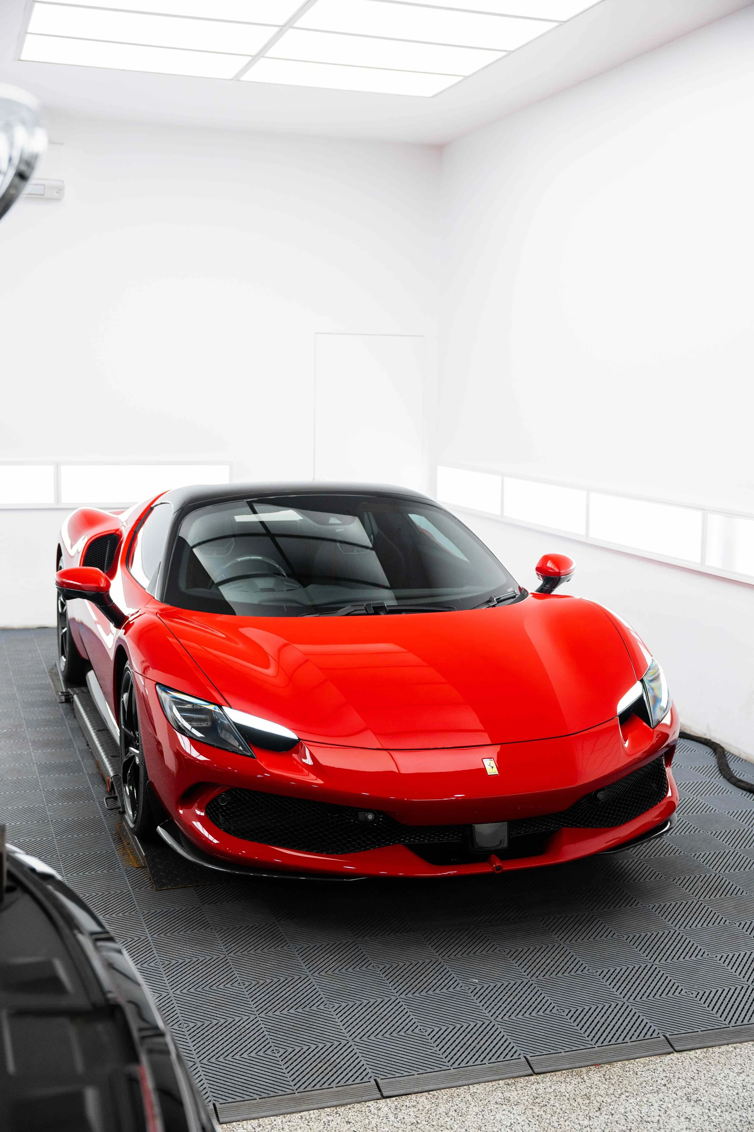Red Ferrari 296 GTS front three quarter in studio with XPEL Paint Protection Film in Mona Vale