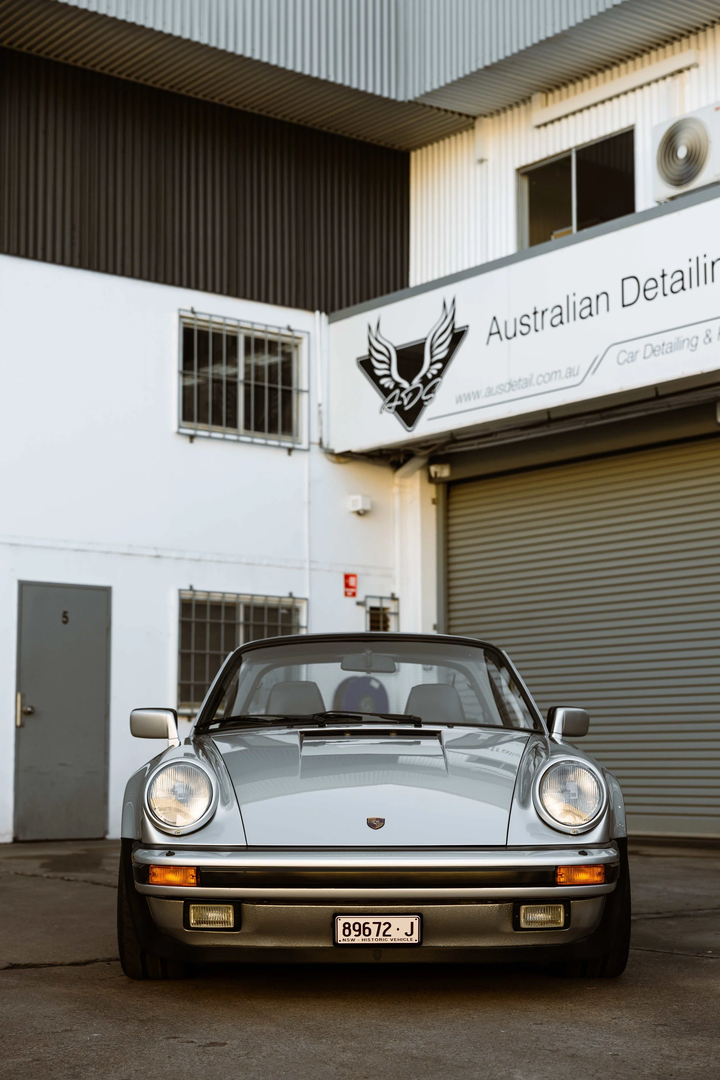 Silver 1989 Porsche 911 Carrera Targa front view outside Australian Detailing Services in Sydney