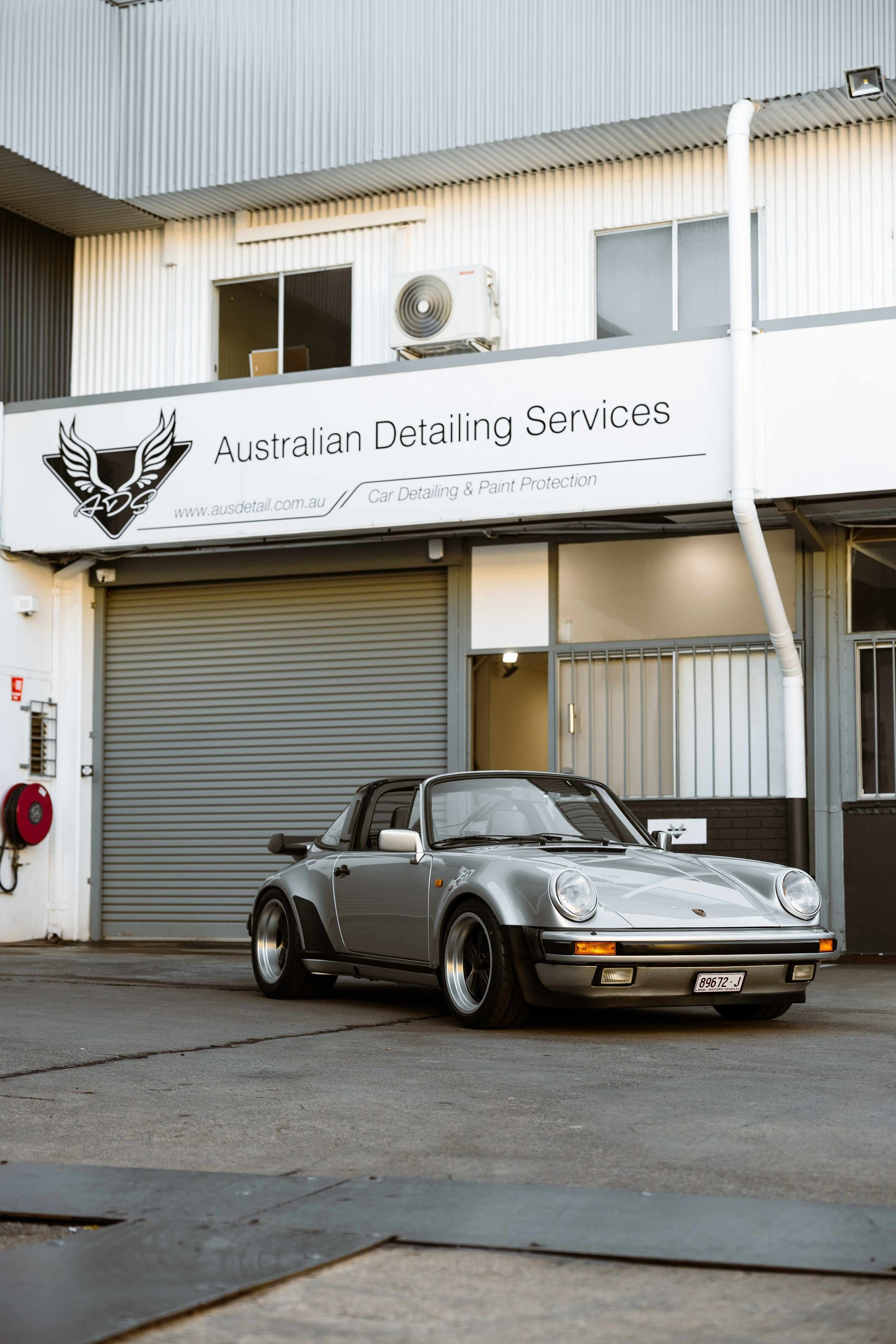 Silver 1989 Porsche 911 Carrera Targa front view outside Australian Detailing Services in Sydney