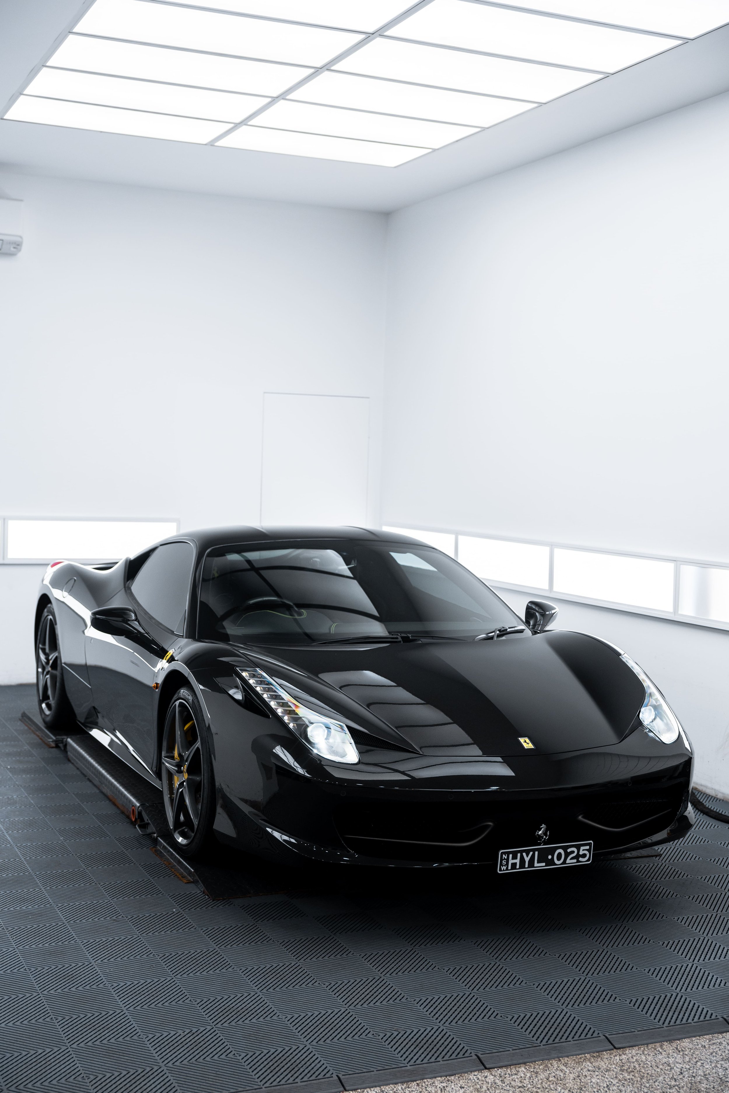 Black Ferrari 458 with full PPF protection by ADS in Mona Vale inside detailing studio