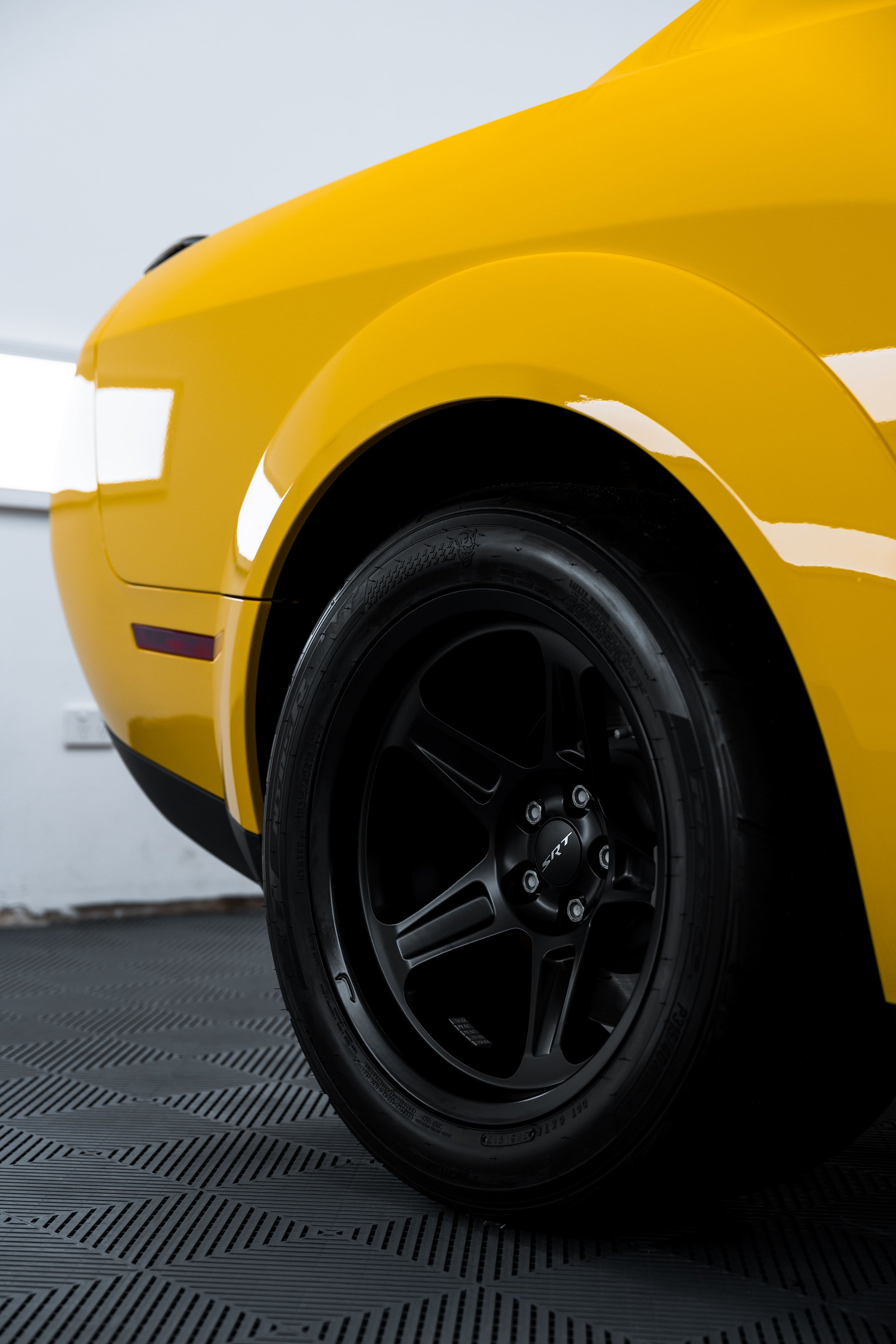 Close-up of yellow Dodge Challenger SRT Demon rear wheel and widebody arch with PPF by ADS in Mona Vale