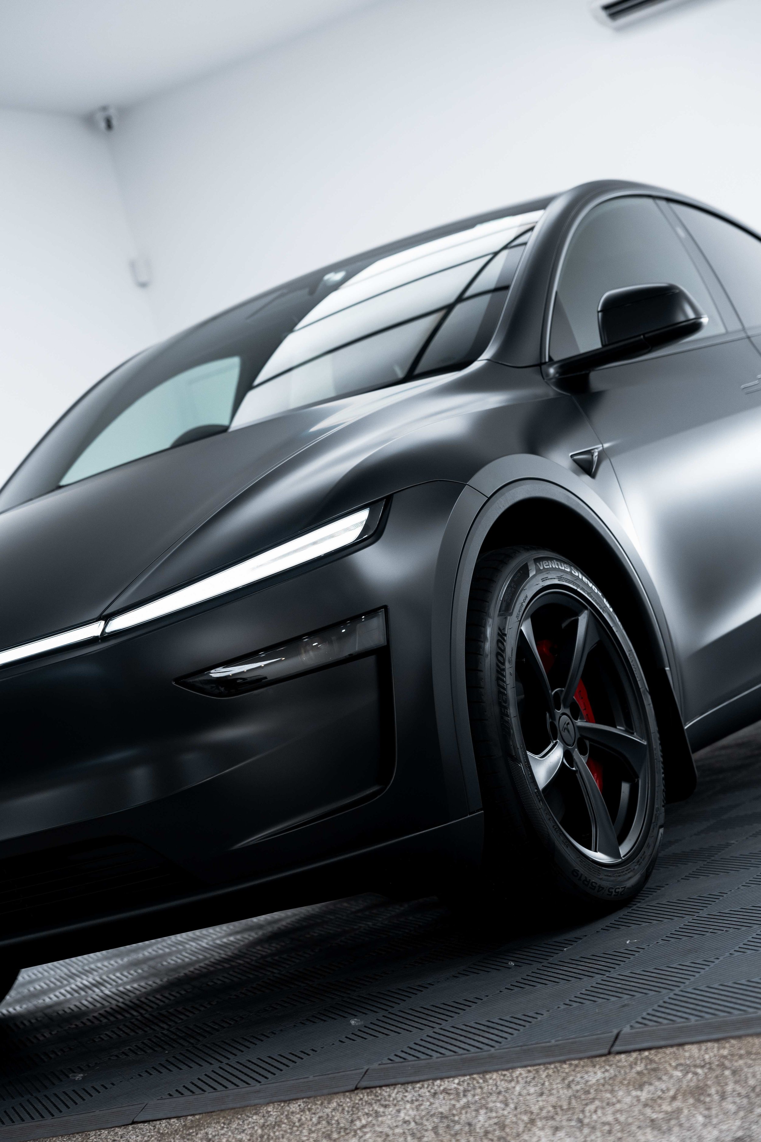 Matte black Tesla Model Y front quarter and wheel with XPEL Stealth Paint Protection Film in Sydney