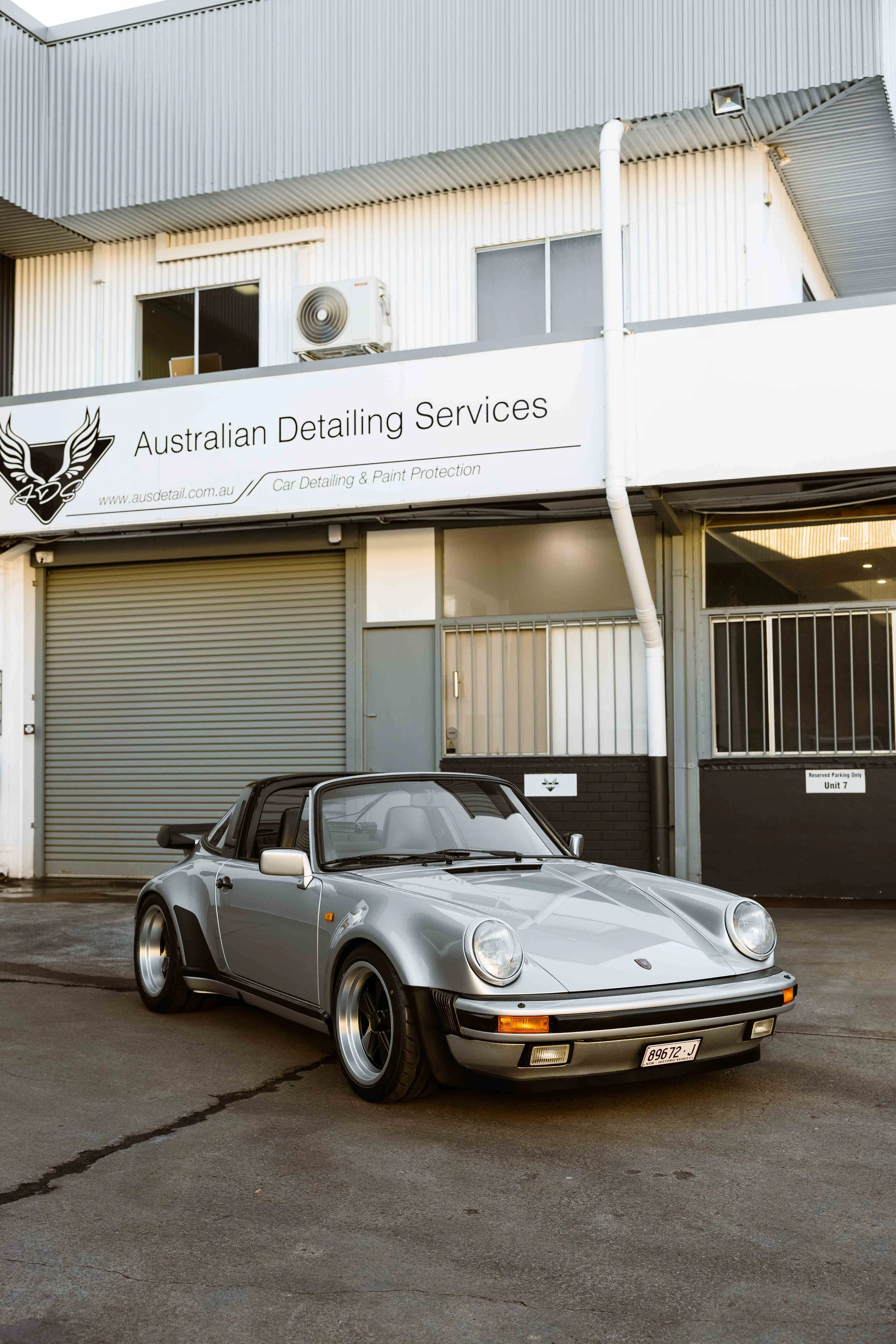 Silver 1989 Porsche 911 Carrera Targa front three quarter with front end XPEL Paint Protection Film in Mona Vale