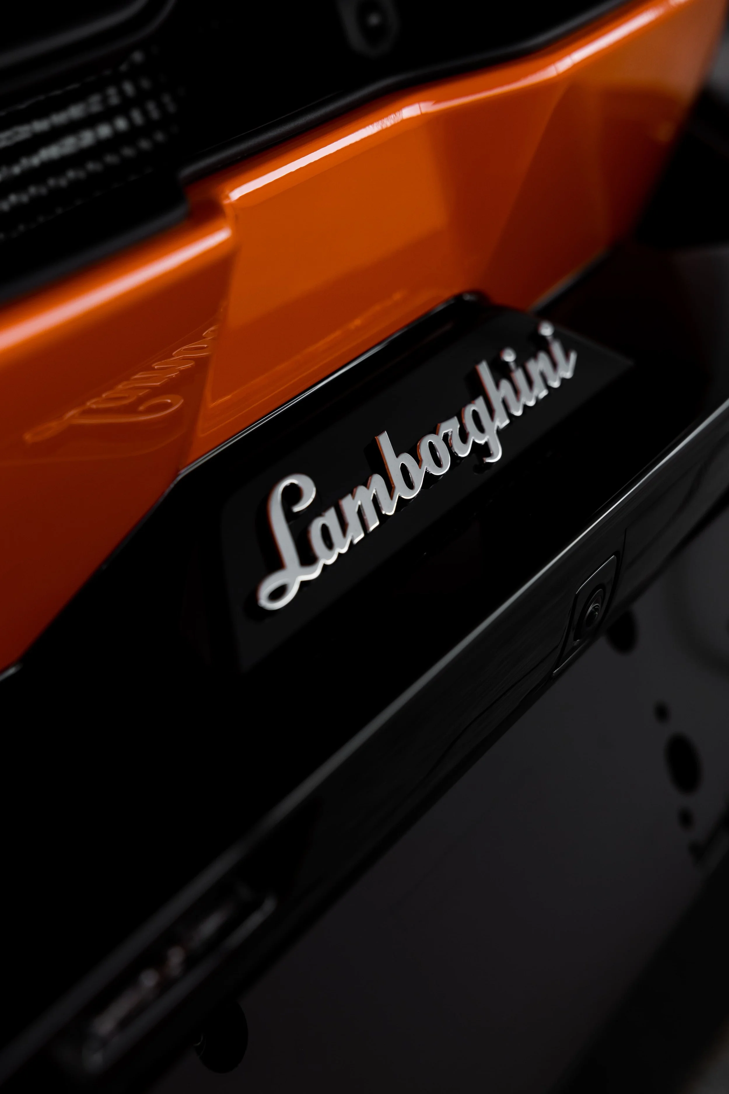 Lamborghini Revuelto rear badge detail in orange with full PPF by ADS in Mona Vale