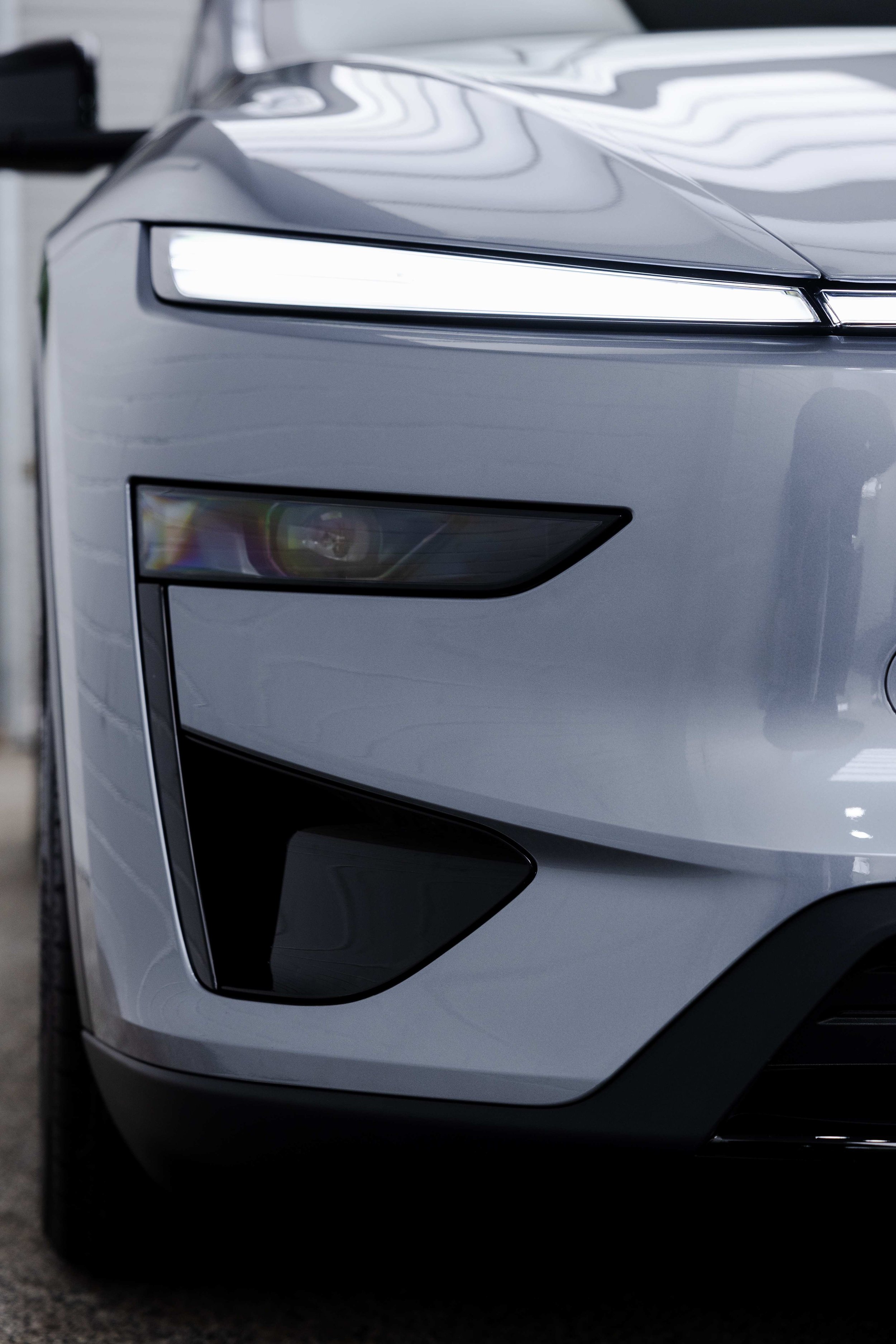 Silver Tesla Model Y front light bar and headlight detail with XPEL Paint Protection Film in Sydney