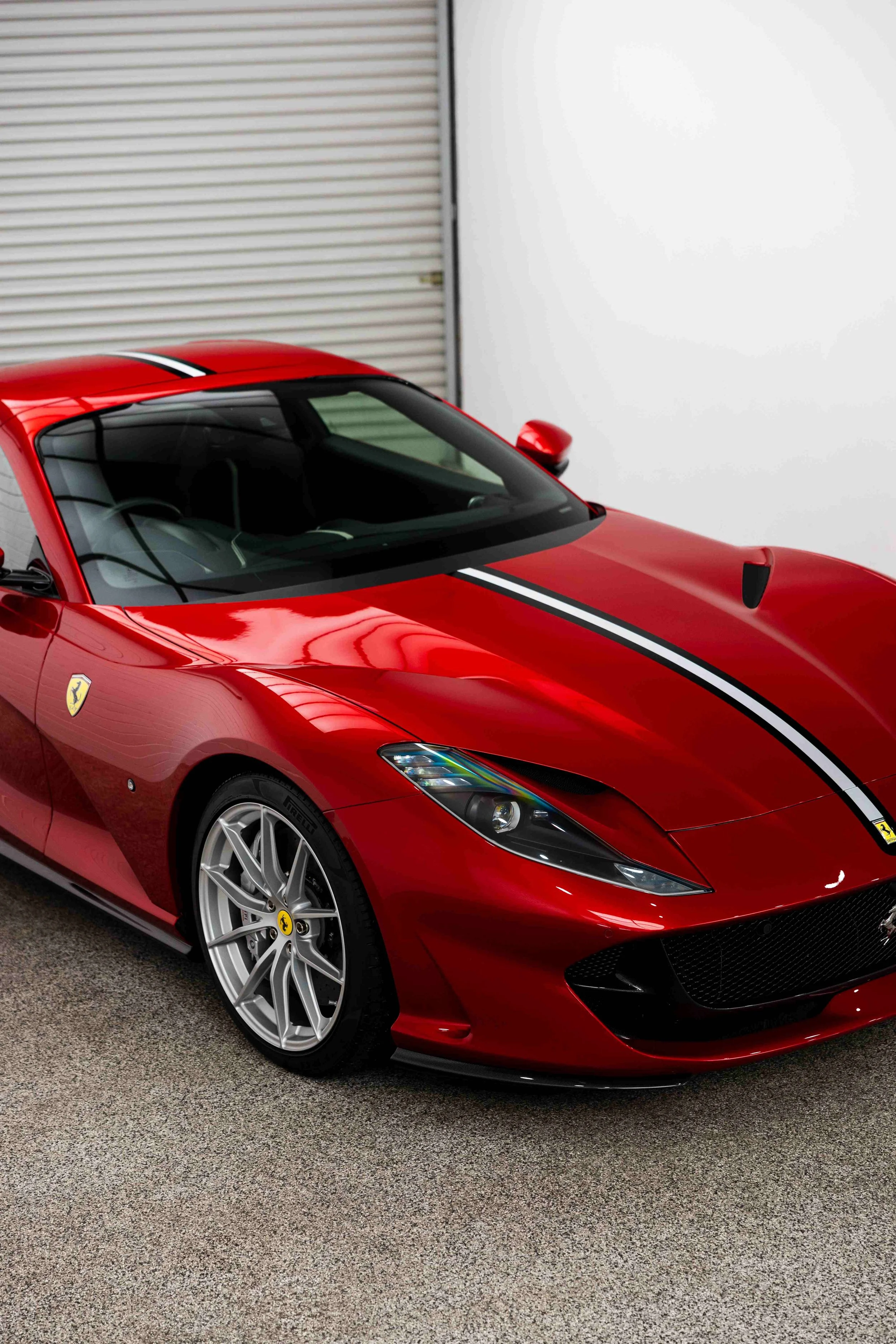Red Ferrari 812 GTS front three quarter in studio with XPEL Paint Protection Film in Mona Vale