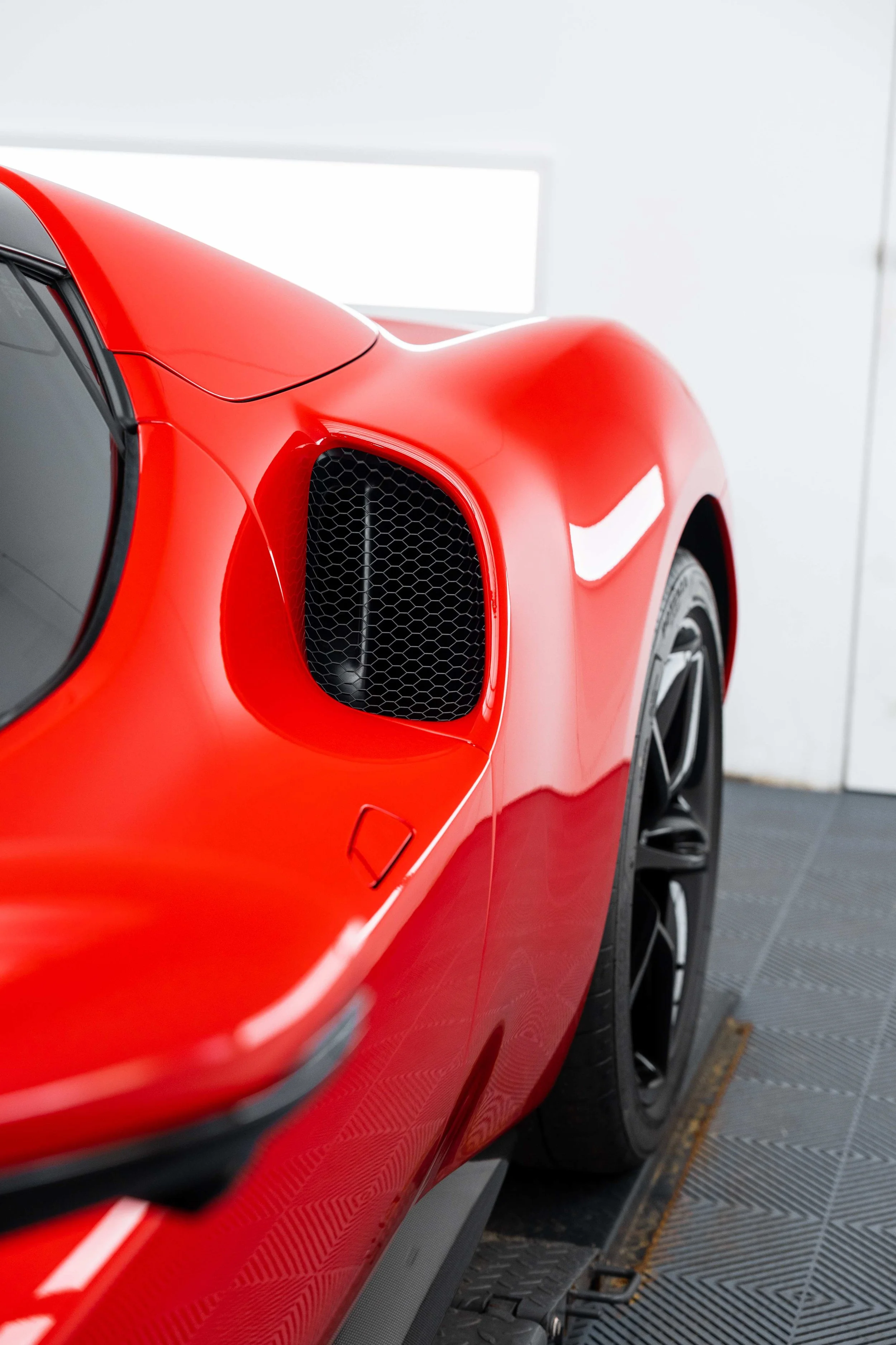 Red Ferrari 296 GTS side air intake and door detail with XPEL Paint Protection Film in Sydney