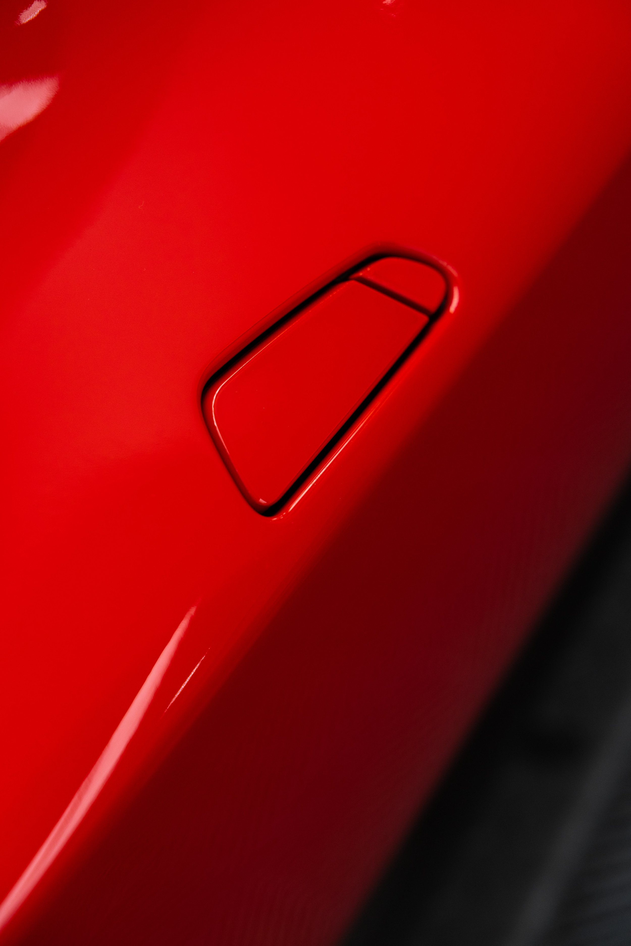 Red Ferrari 296 GTS door handle detail with XPEL Paint Protection Film in Mona Vale