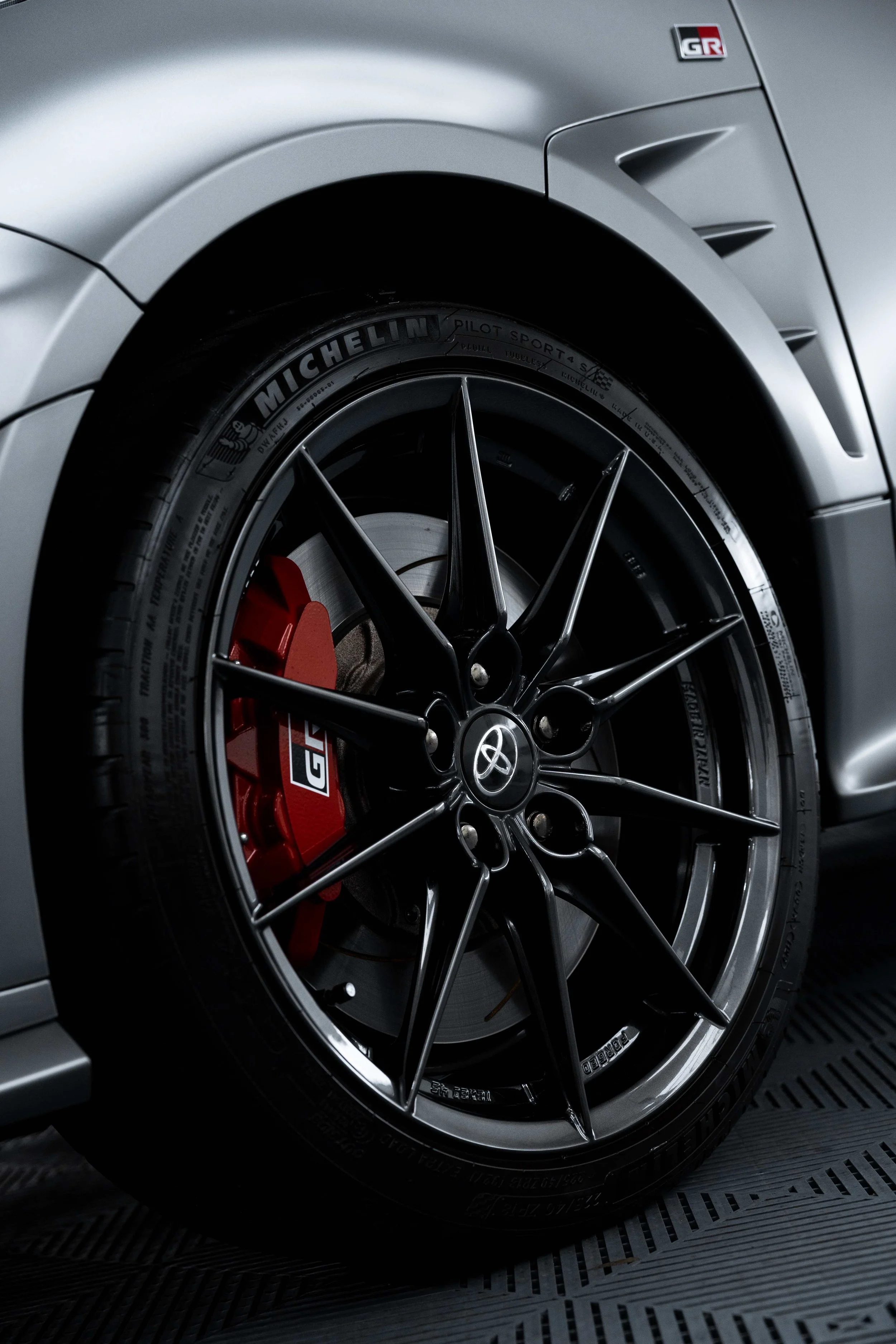 Matte grey Toyota GR Yaris wheel and red brake caliper with GR badge in Mona Vale