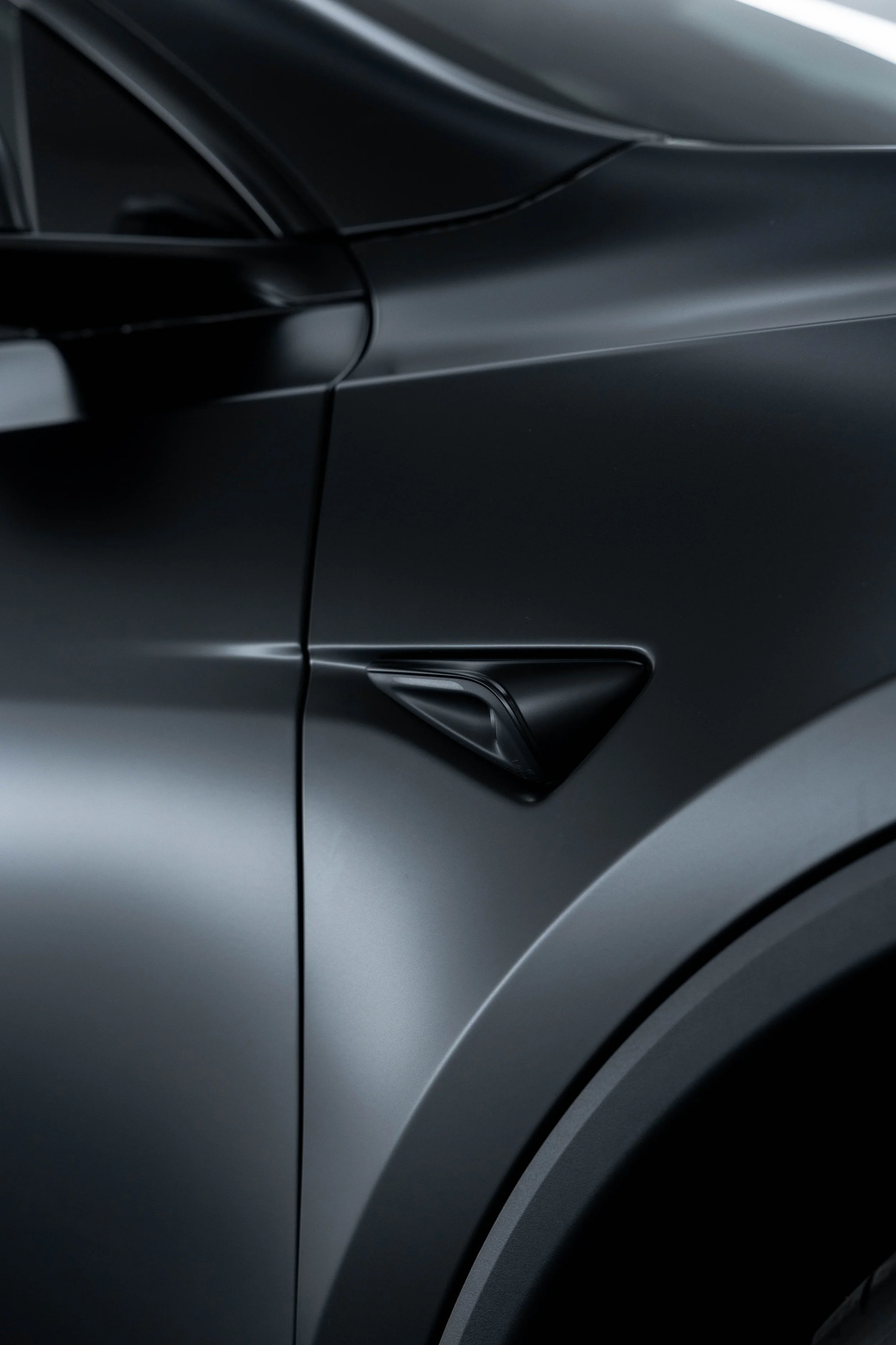 Matte black Tesla Model Y front guard and sensor with XPEL Stealth Paint Protection Film in Mona Vale