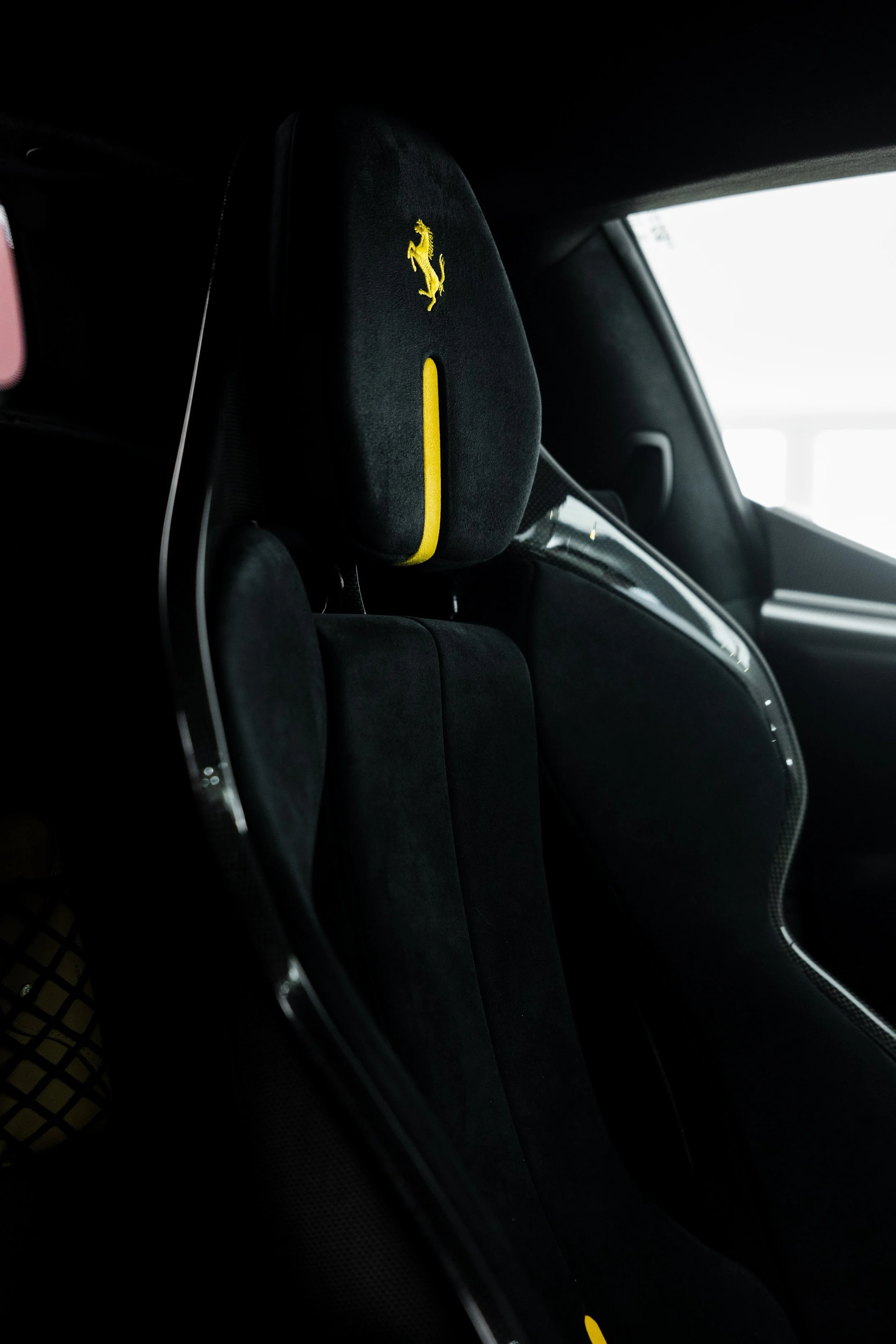 Red Ferrari 296 Speciale interior detailing racing seat with yellow Prancing Horse headrest in Sydney
